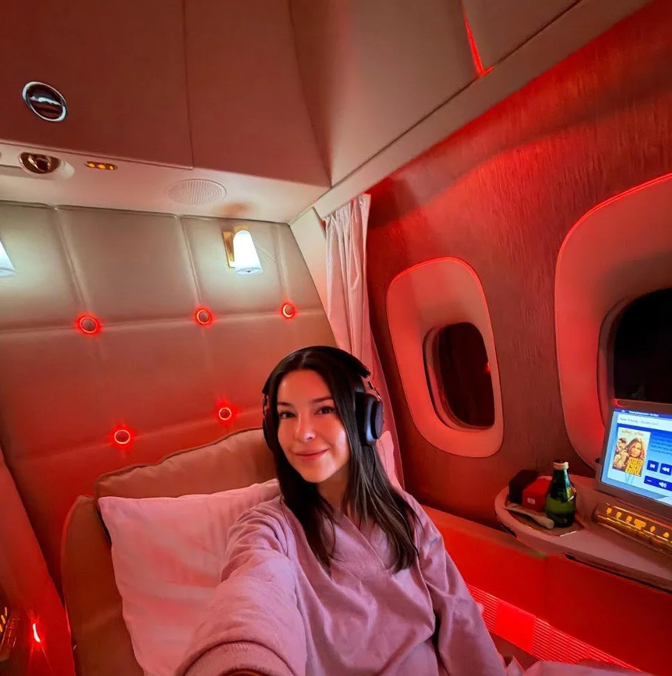 Rachel Points relaxing in a private first class suite with red cabin lighting