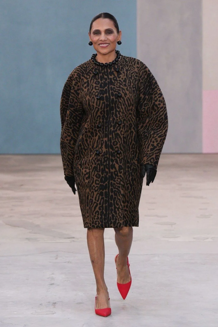 Photographer Ming Smith walking the Carolina Herrera AW26 runway at NYFW against Sarah Oliphant painted backdrop February 2026