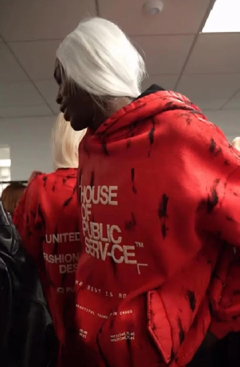Model on the runway in Raphael Young's The Rest Is Noise SS27 collection for House of Public Serv-ce at New York Fashion Week blood red outerwear