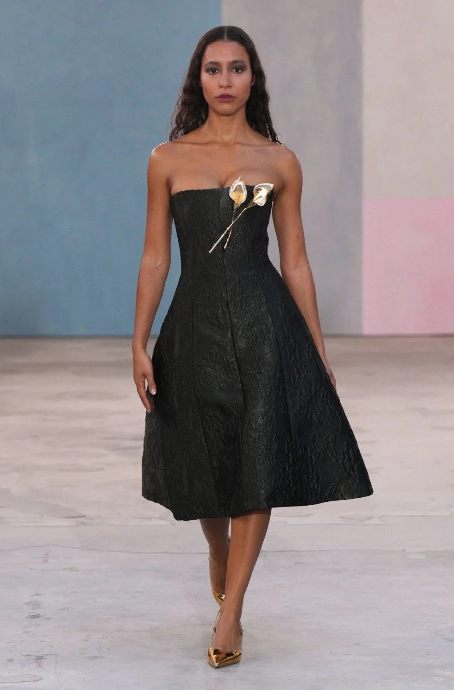 Artist Hannah Traore walking the Carolina Herrera AW26 runway at NYFW against Sarah Oliphant painted backdrop February 2026