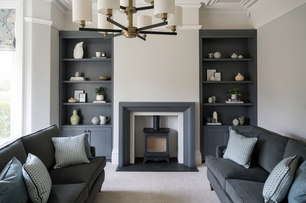 Contemporary living room with bespoke shelving, feature fireplace and soft neutral furnishings designed by StyleSmith Interiors, serving Harrogate, Leeds, York and Yorkshire.