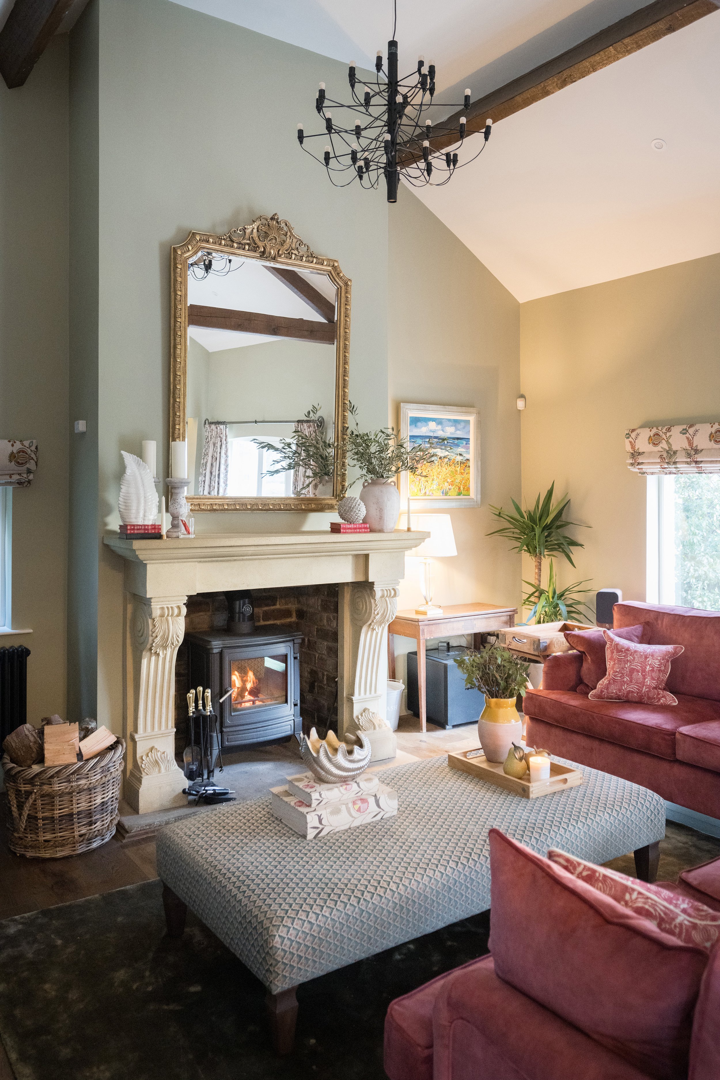 Traditional living room designed by StyleSmith Interiors featuring a stone fireplace, wood-burning stove, warm neutral tones and elegant furnishings in a Yorkshire home