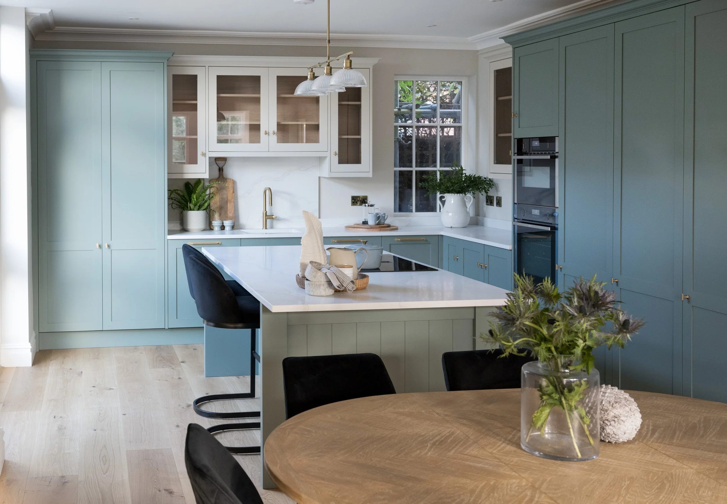 Classic shaker kitchen designed by StyleSmith Interiors with painted cabinetry, quartz worktops and a spacious island in a family home