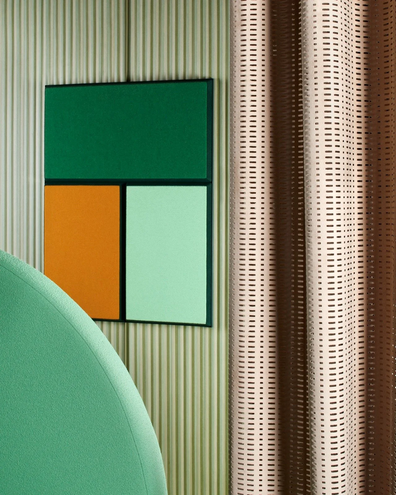 Colorful wall art with three rectangles in green, yellow, and light blue on a striped wall, next to patterned curtains.