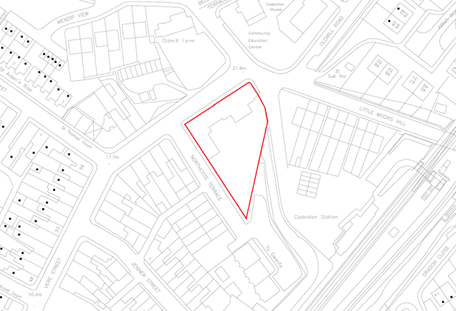 A landscape with a lake surrounded by green hills and mountains under a cloudy sky.