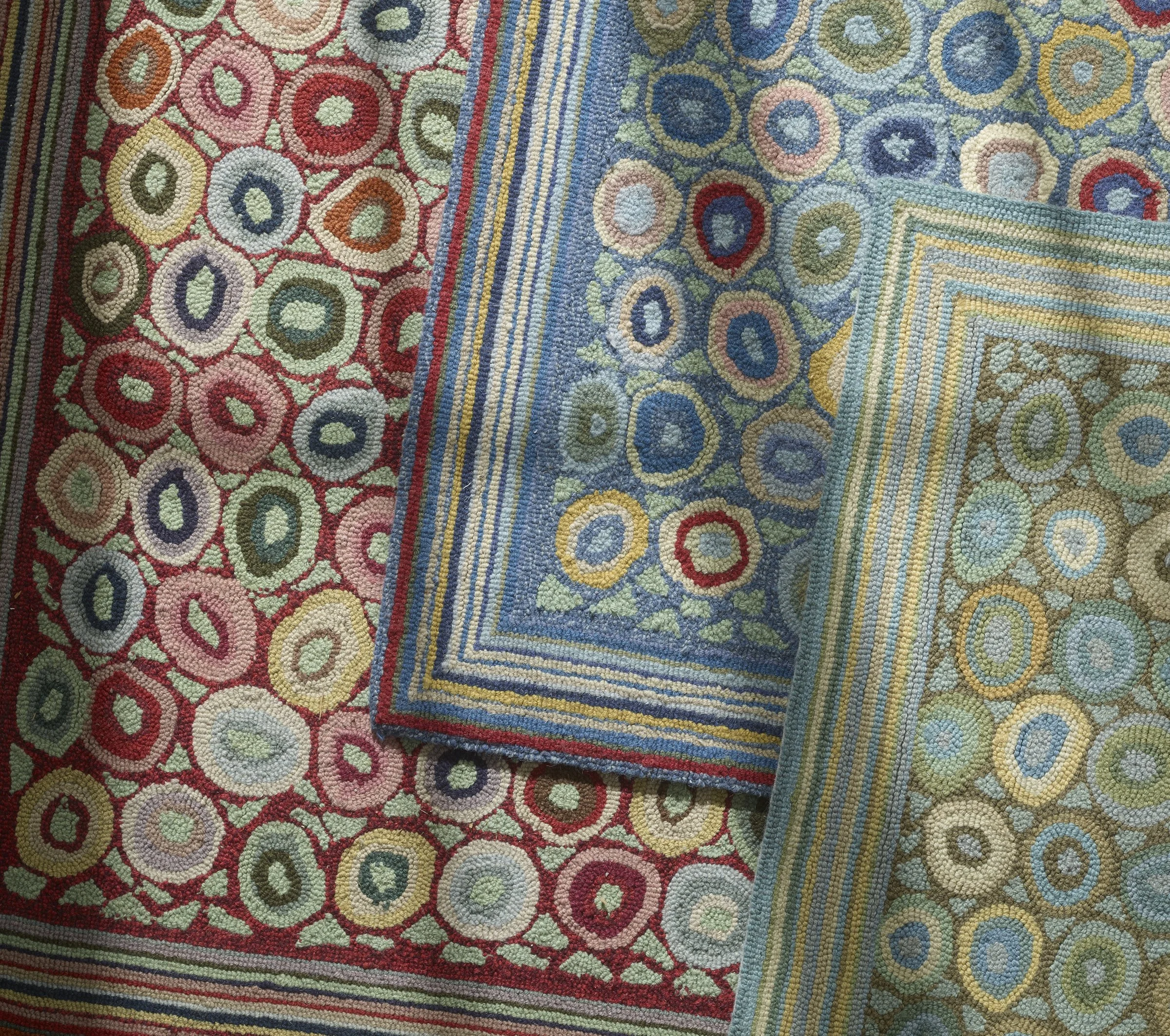 Close-up of a colorful, detailed, woven tapestry with intricate geometric patterns in red, blue, yellow, and green.
