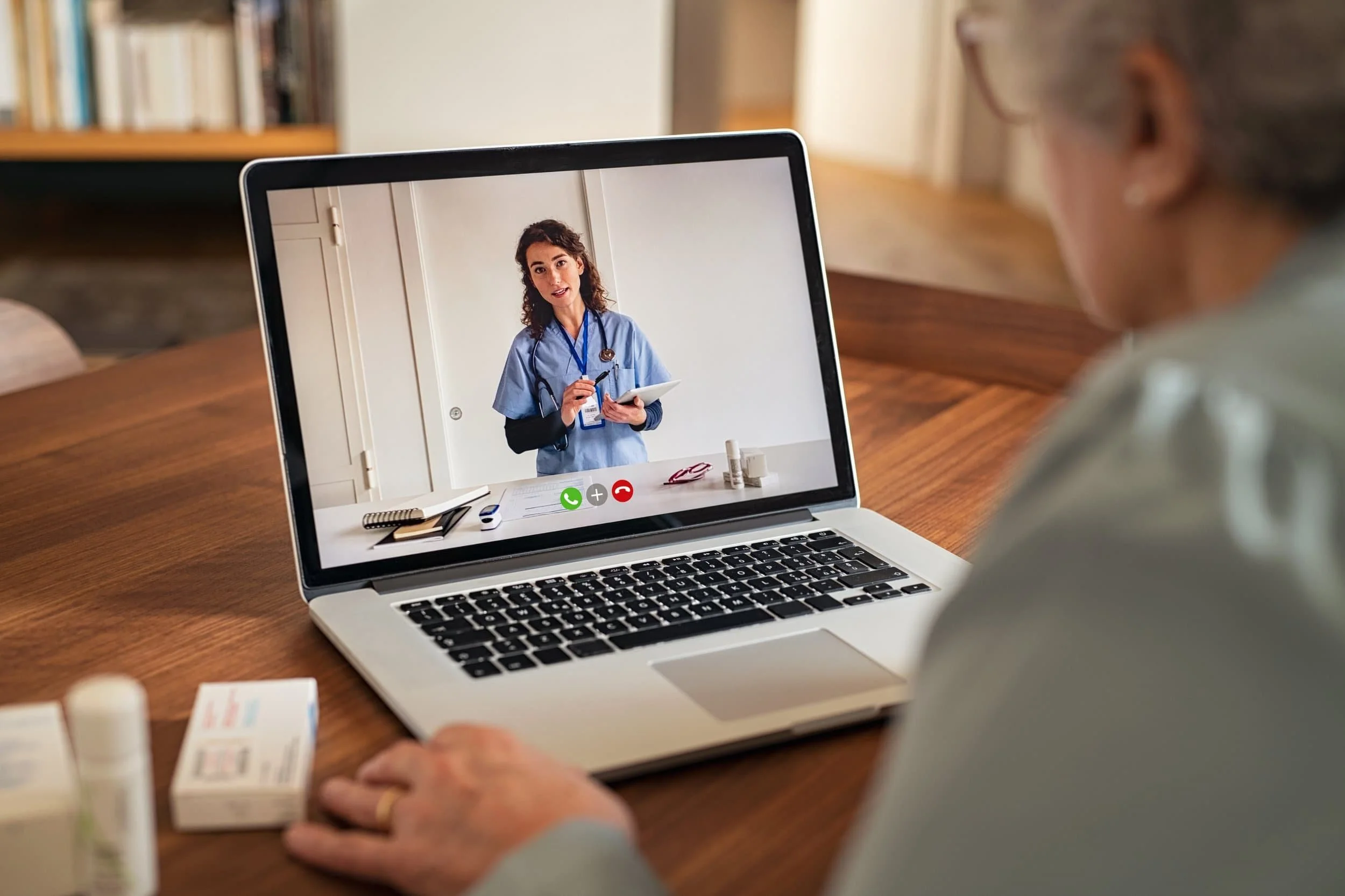 Elderly patient on a telemedicine visit with healthcare worker