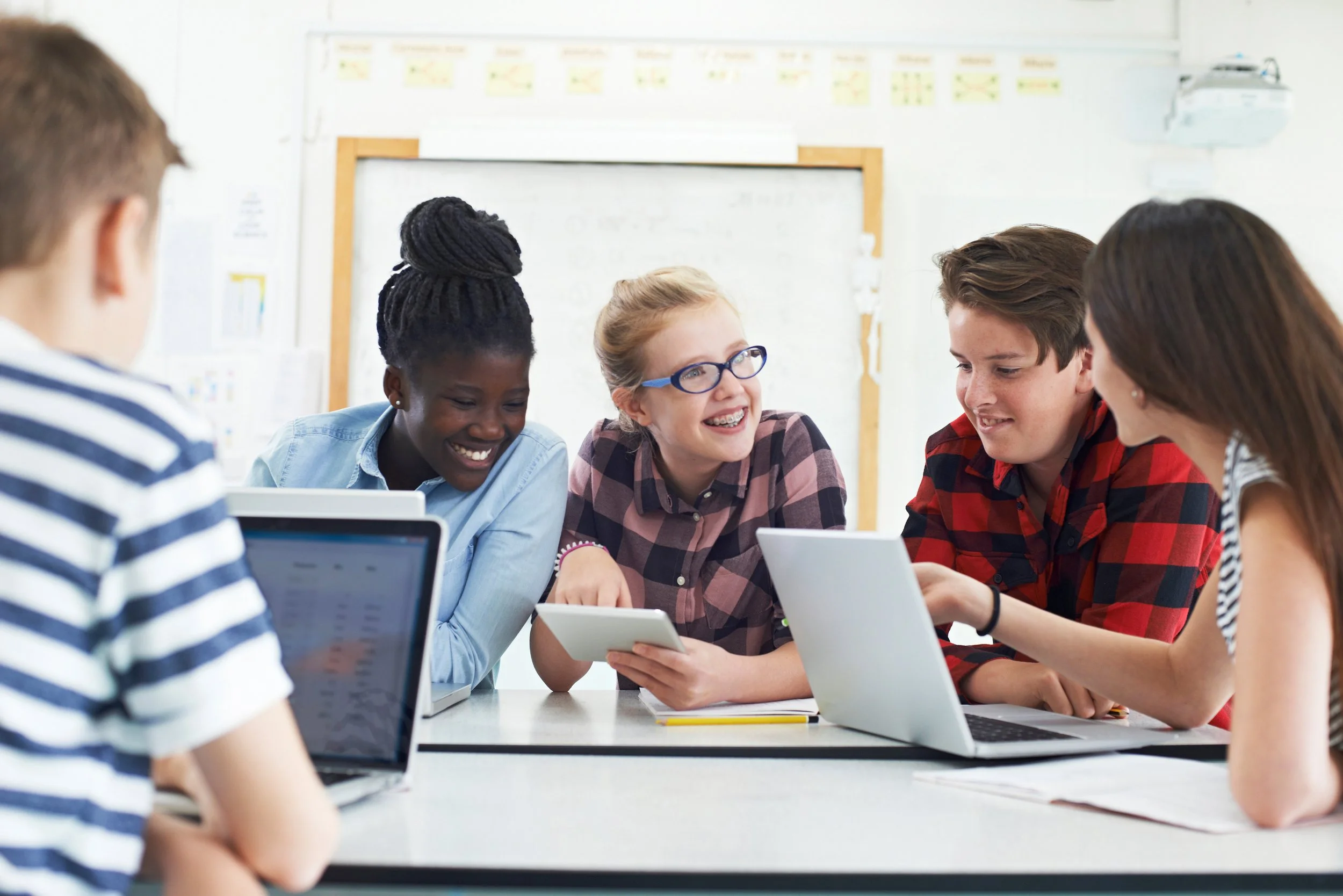 shutterstock_high school students working on laptops.jpg