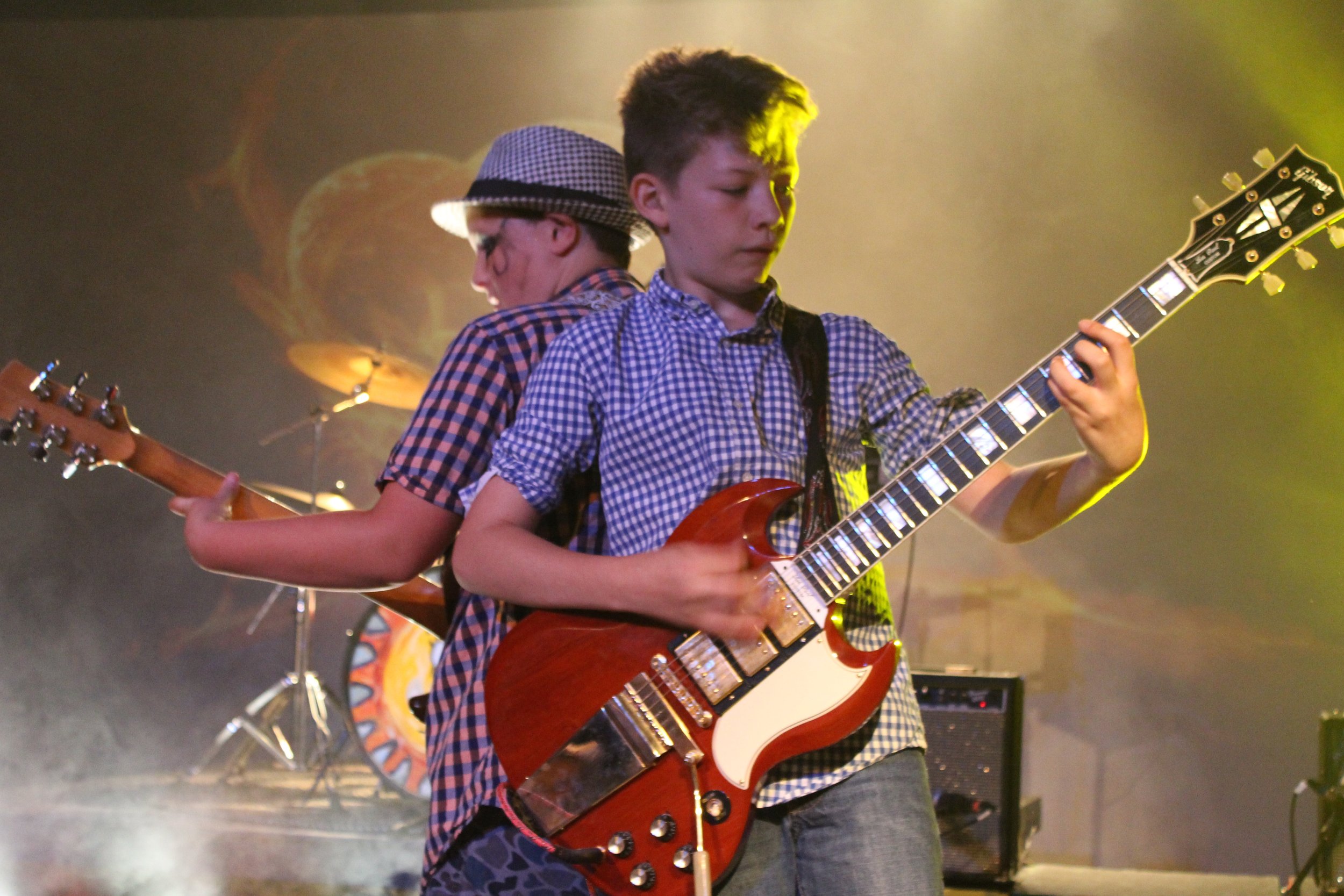 Two campers play guitar back to back during Rock Band Night.