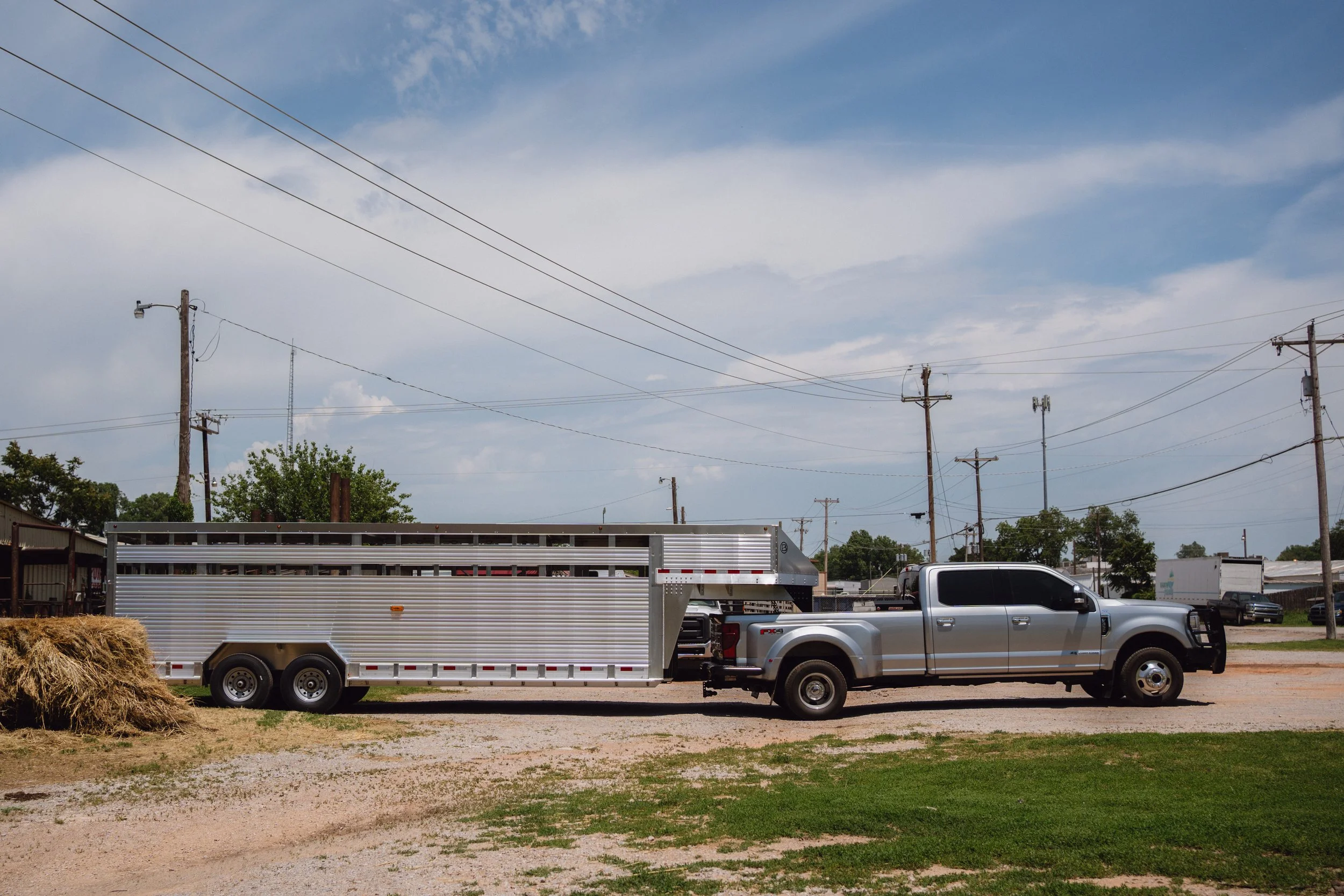 Barrett gooseneck cattle trailer attached to pickup truck