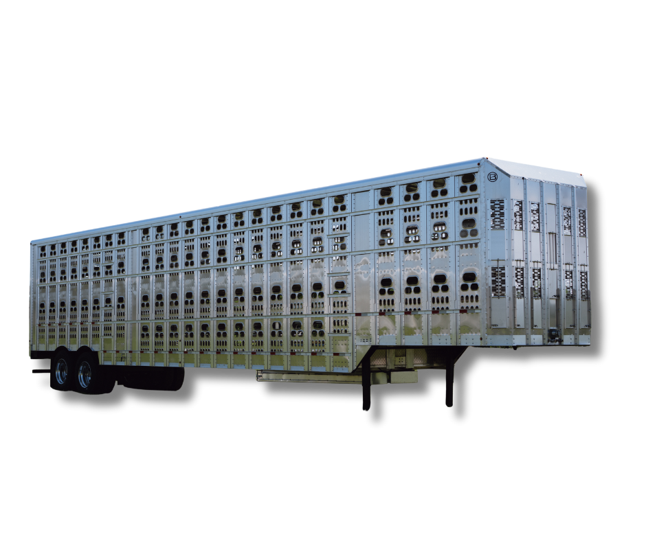 Large livestock trailer with a metallic exterior and multiple ventilation holes, isolated on a black background.