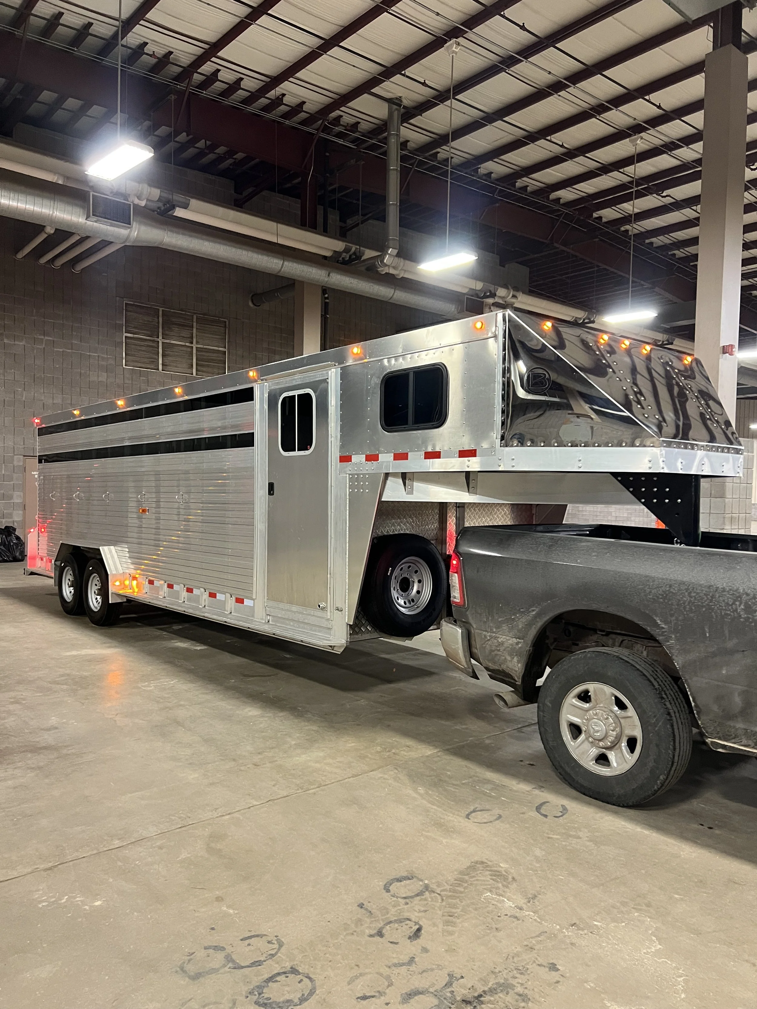 Side profile of a Barrett cattle trailer gooseneck with polished aluminum finish