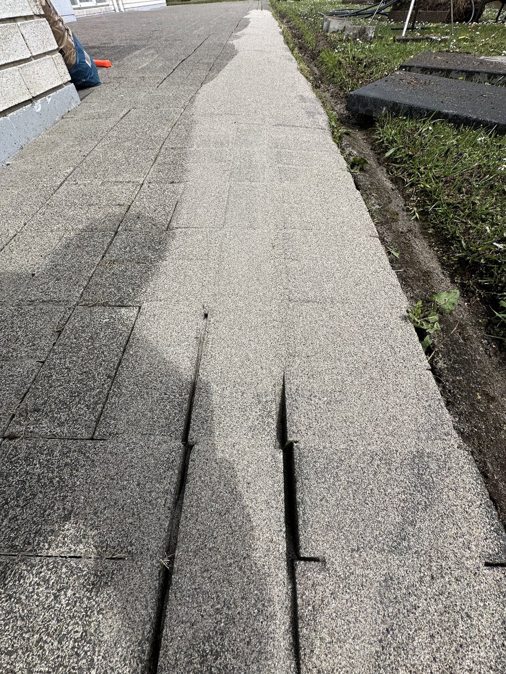 Paving jointing sand with binder being spread across cleaned pavers in Golflands