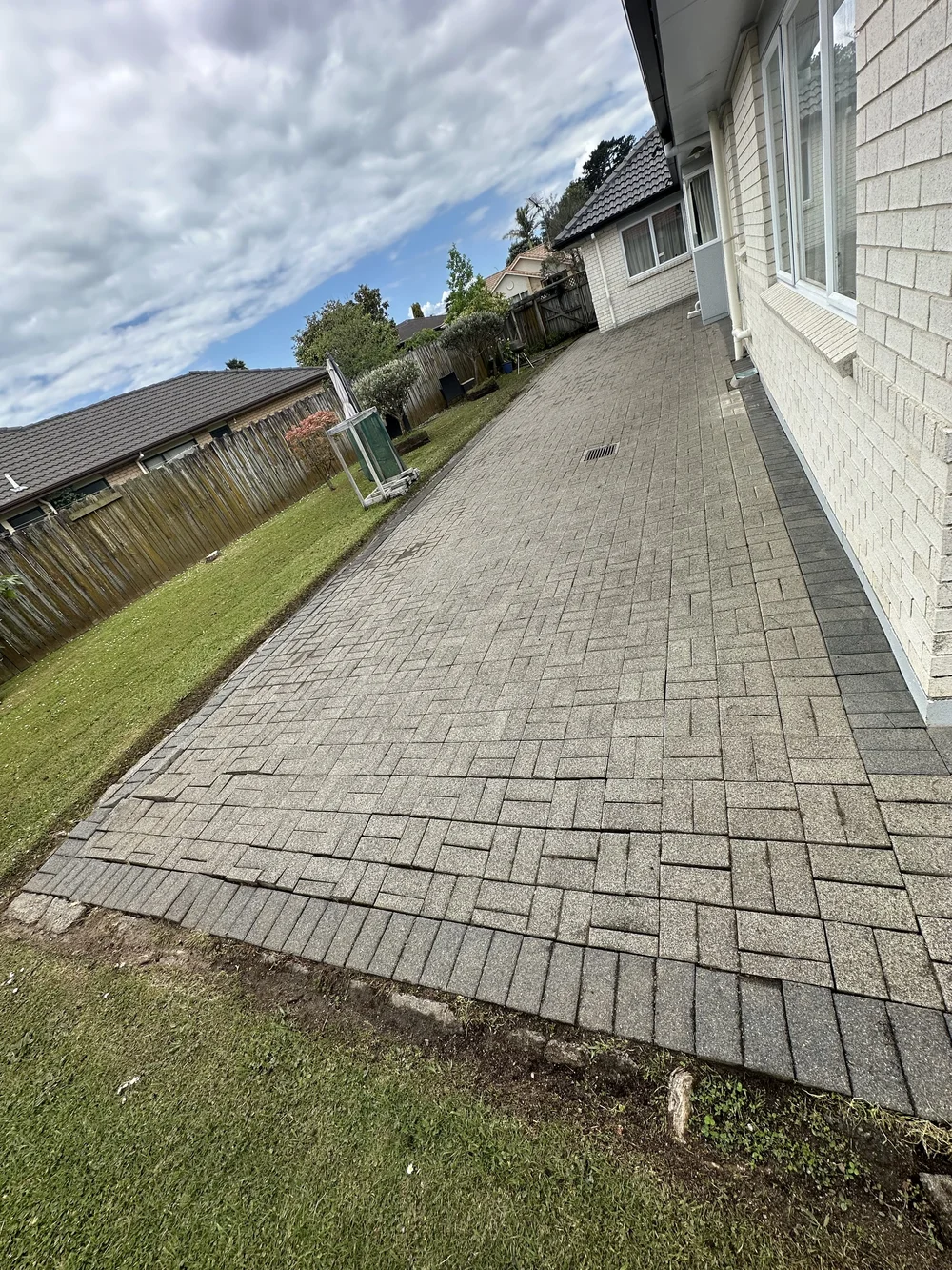 Deep open gaps between clean pavers after water blasting in Golflands before joint restoration