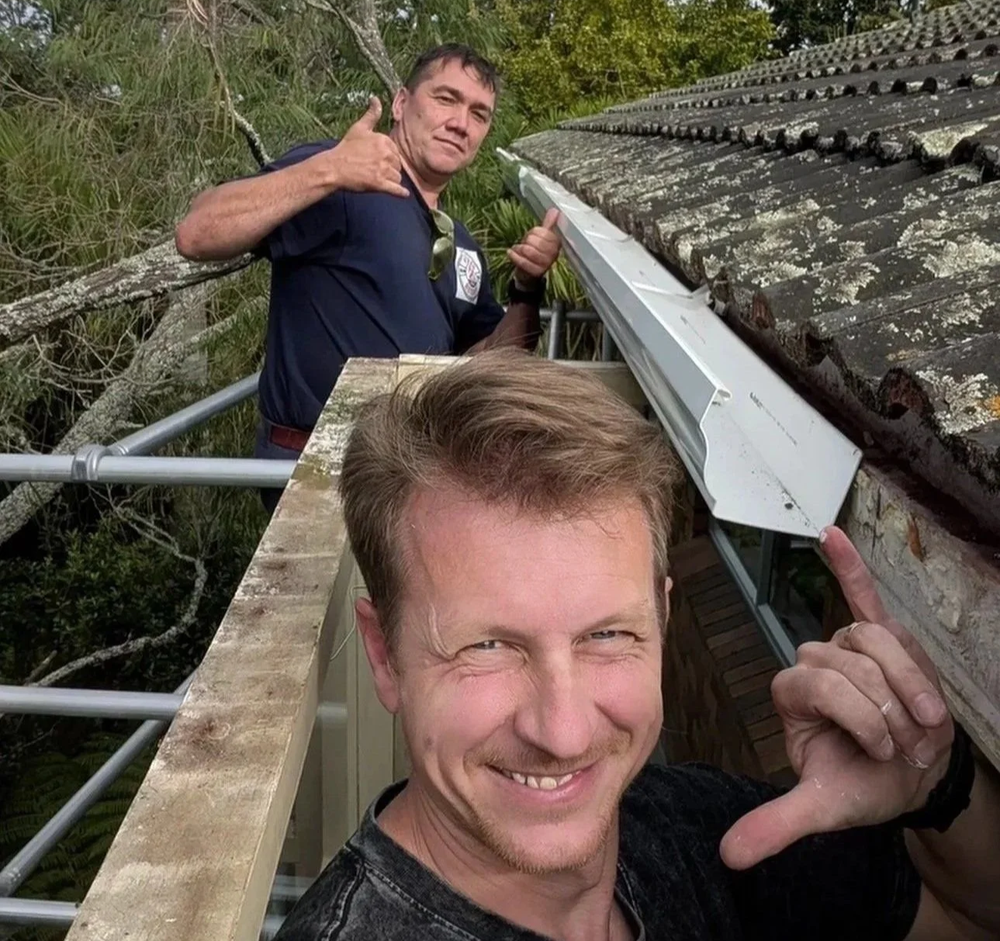 Handyman Botany technicians cleaning gutters on a rooftop in East
Auckland