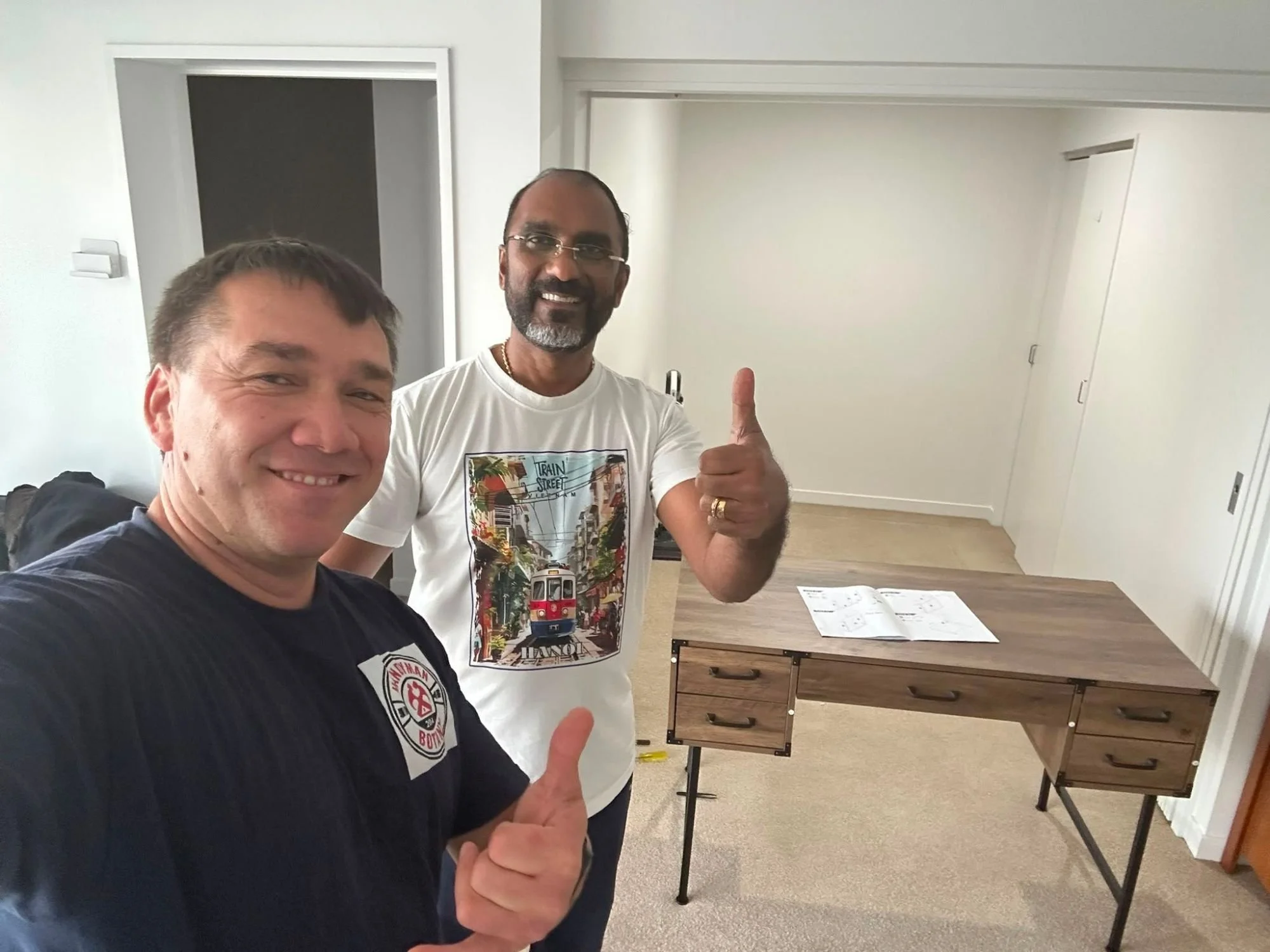 Happy customer with completed flat-pack desk assembly in East Auckland — Handyman Botany furniture service