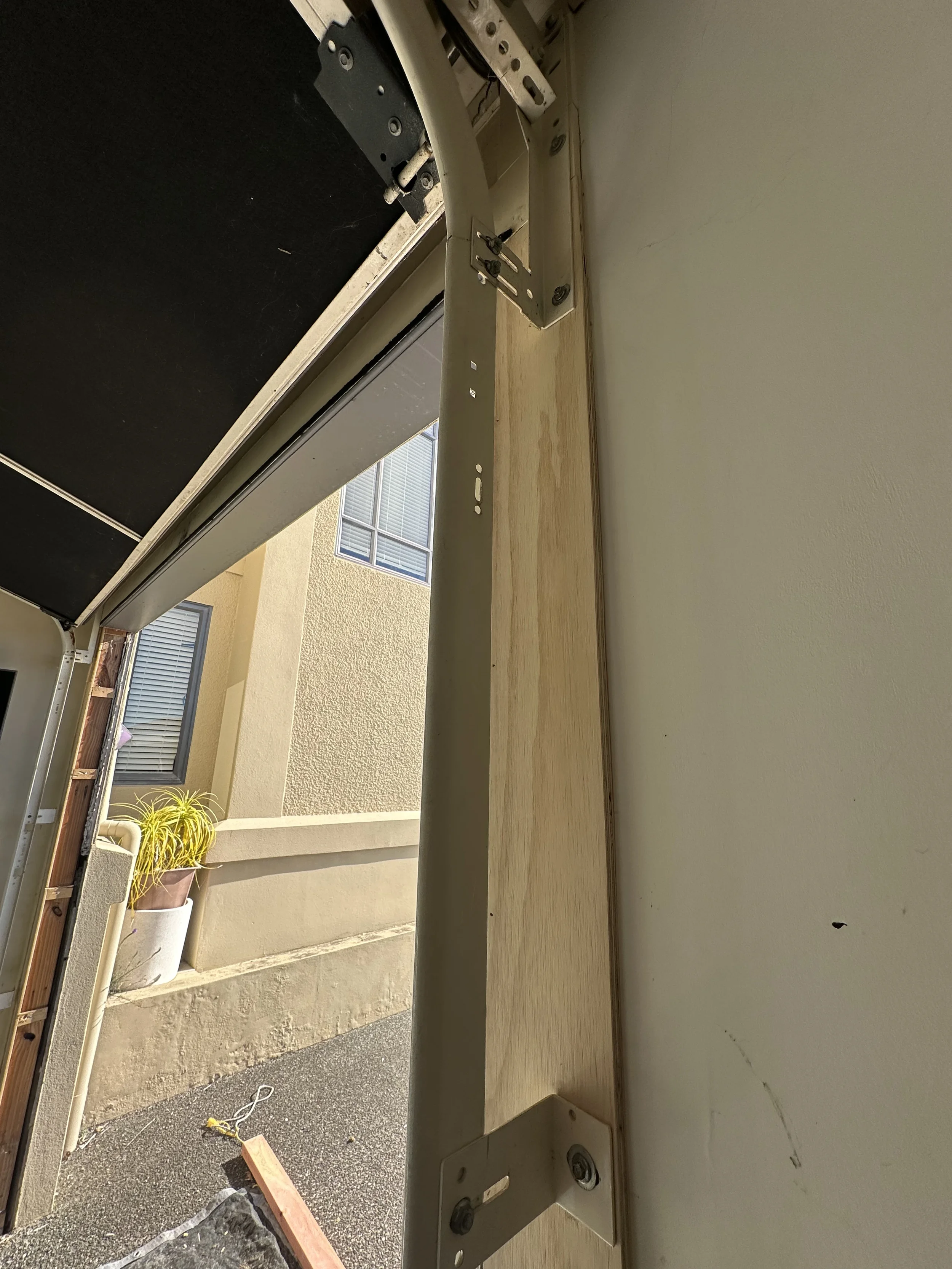 Final fit and clearance check of the repaired garage door jamb and garage door mechanism