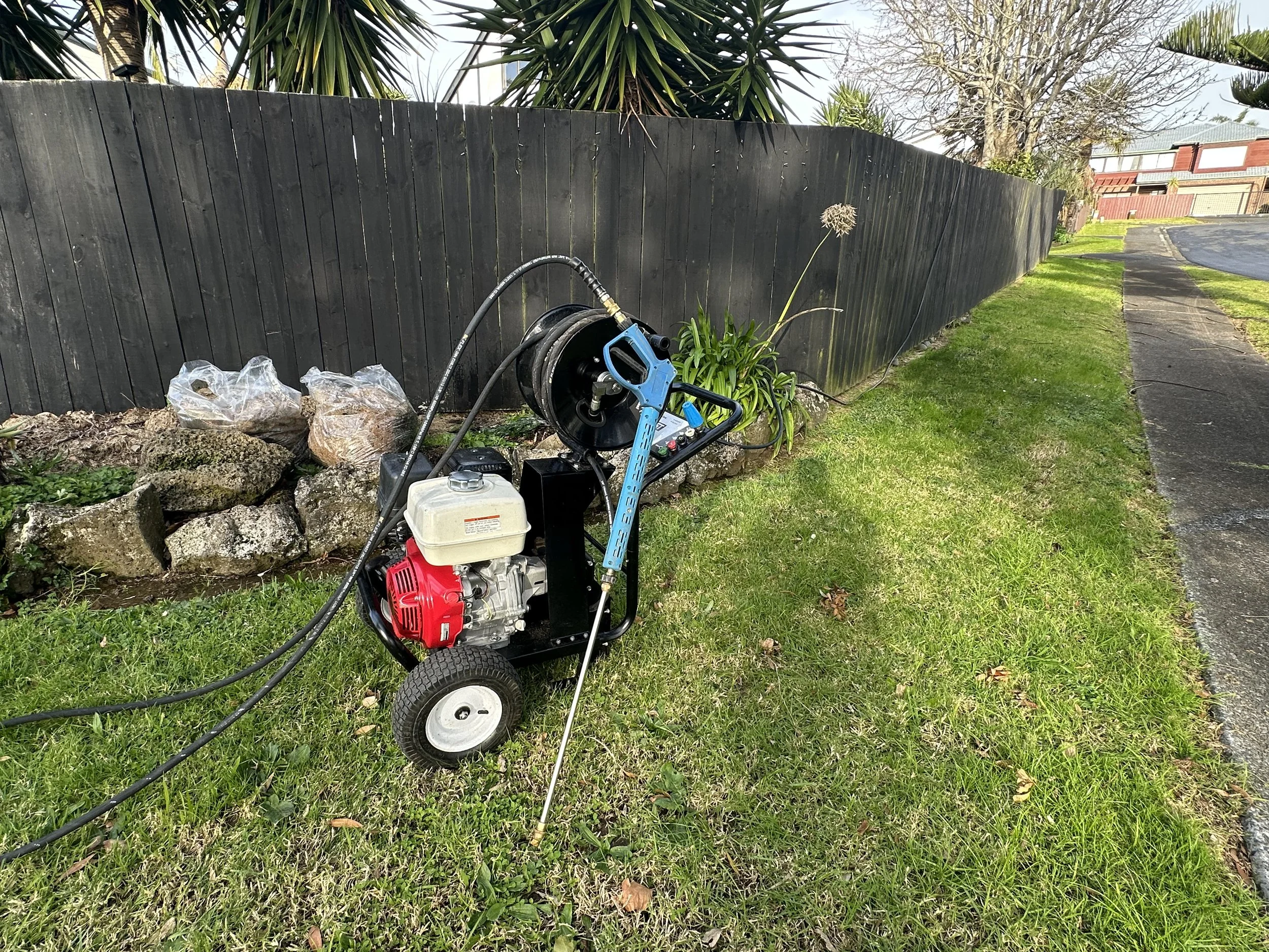 t: High-pressure water blaster with extension wand for fence cleaning in Howick East Auckland