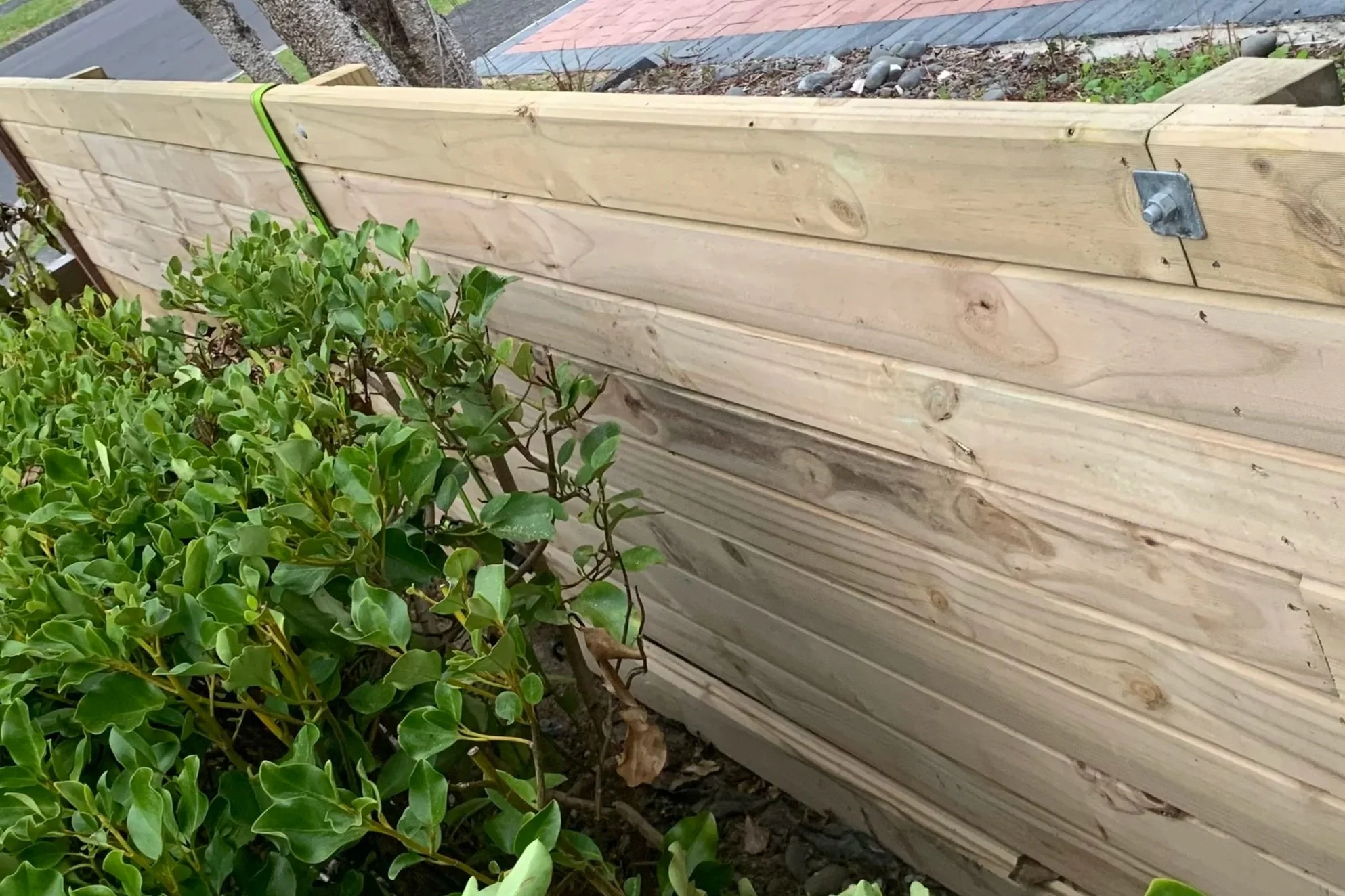 Horizontal timber retaining wall built on sloped garden – Mellons Bay handyman Botany