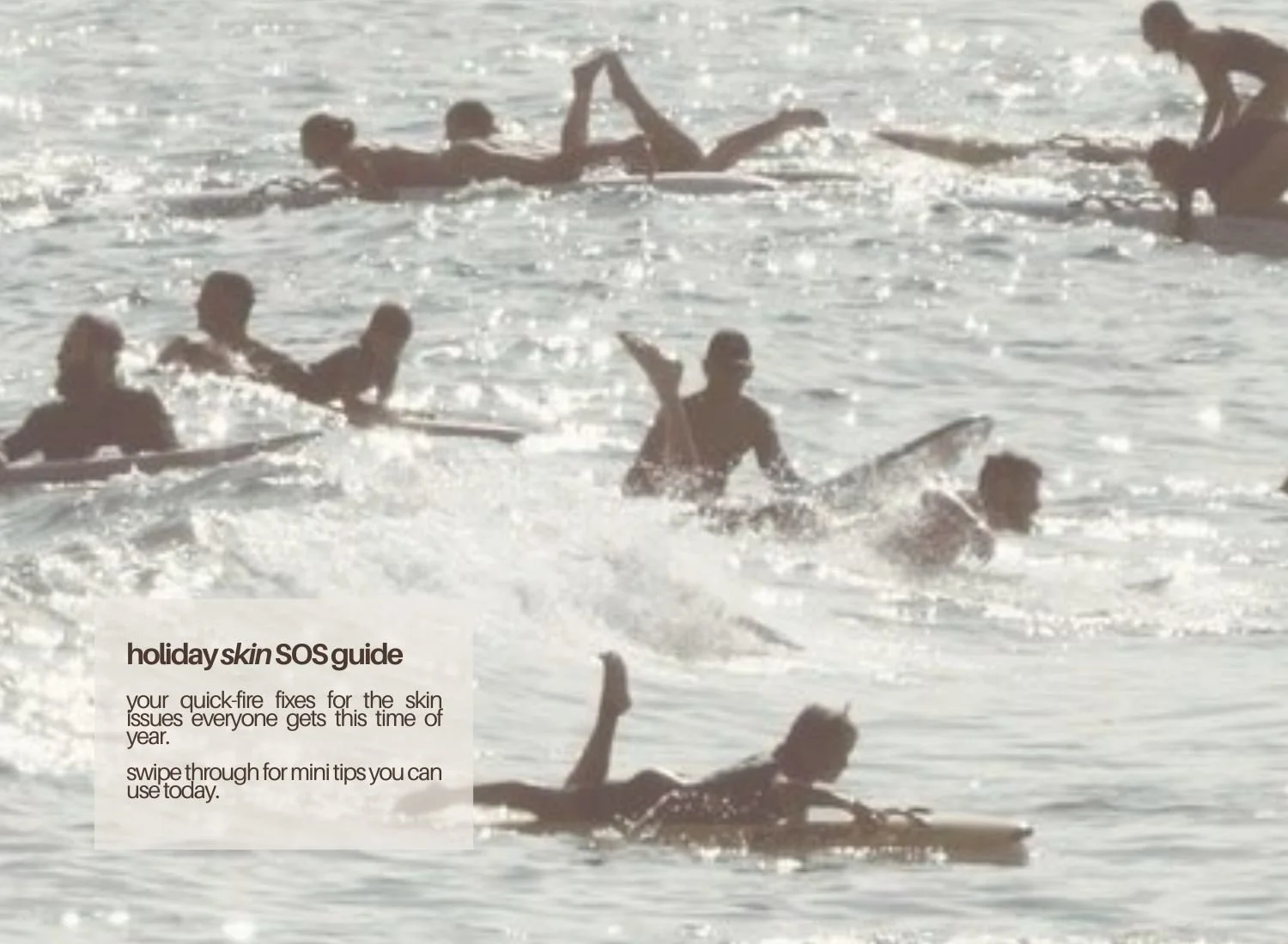 An image of aussies enjoying the beach in the water with surfboards and wiritng saying holiday skin sos guide over the top