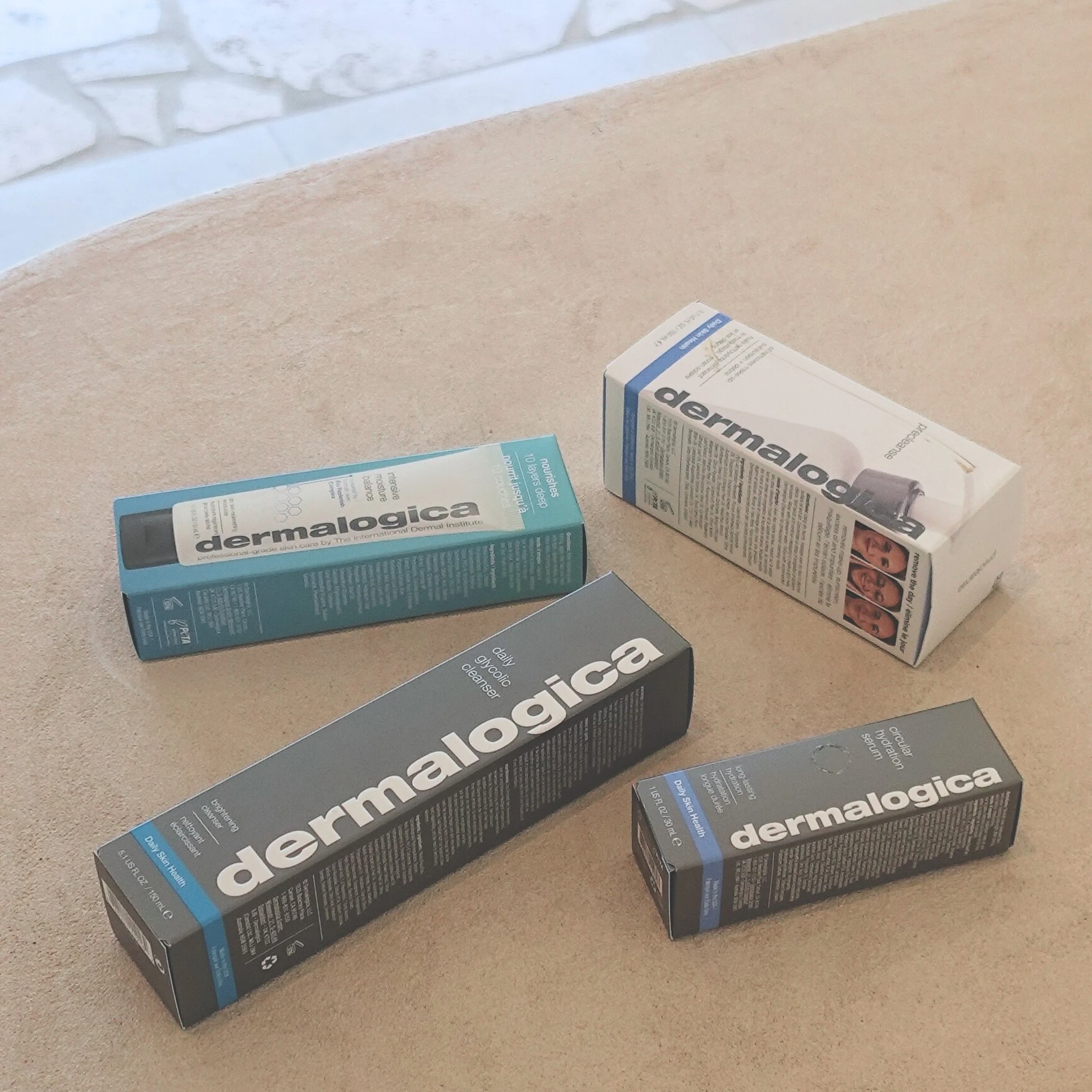 Dermalogica boxes with products inside spread out on a bench in studio at amiri studio newcastle