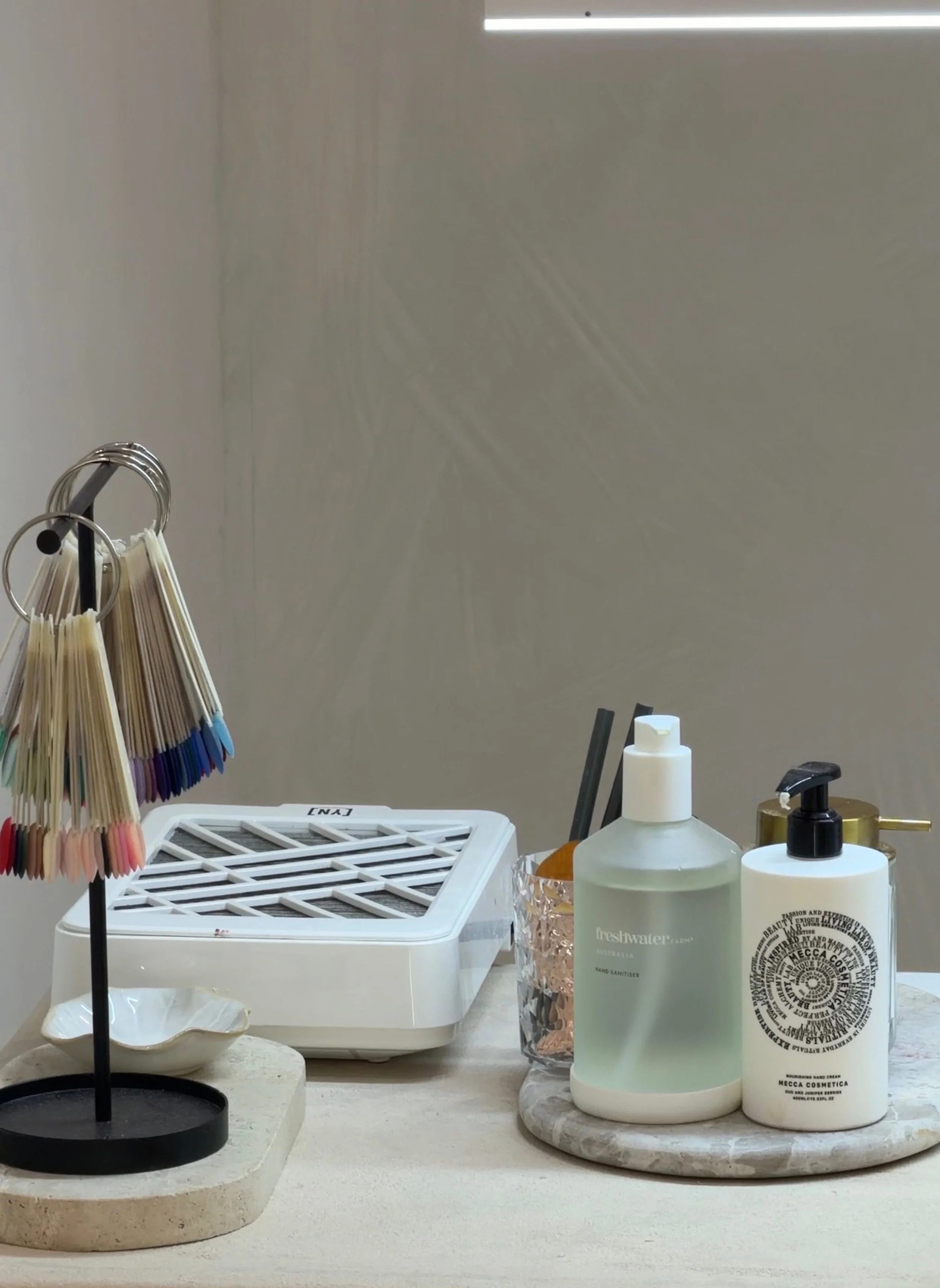 A BIAB Nail Room set up with nails colour options handing and the products lined up.