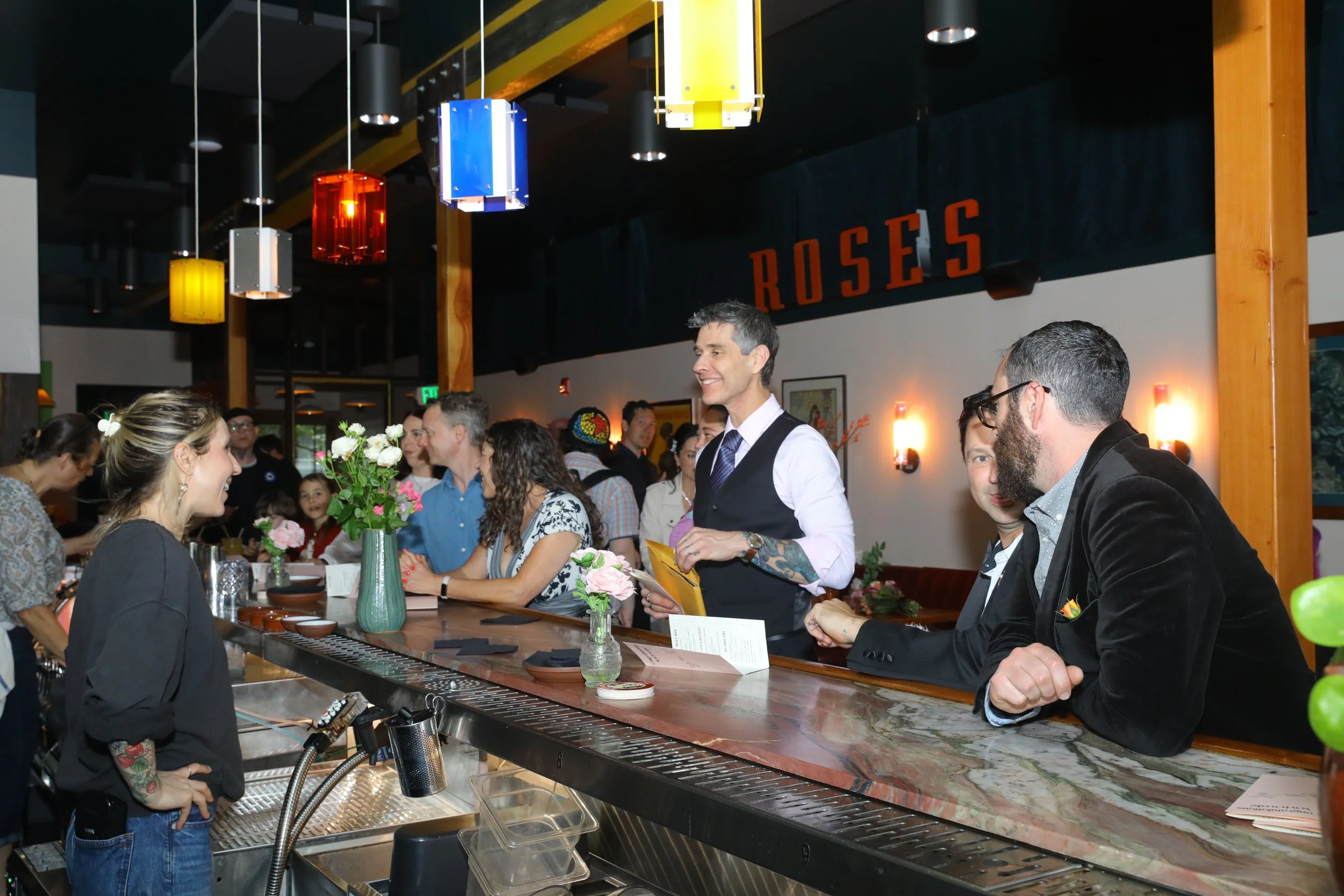 wedding guests ordering drinks from the open bar