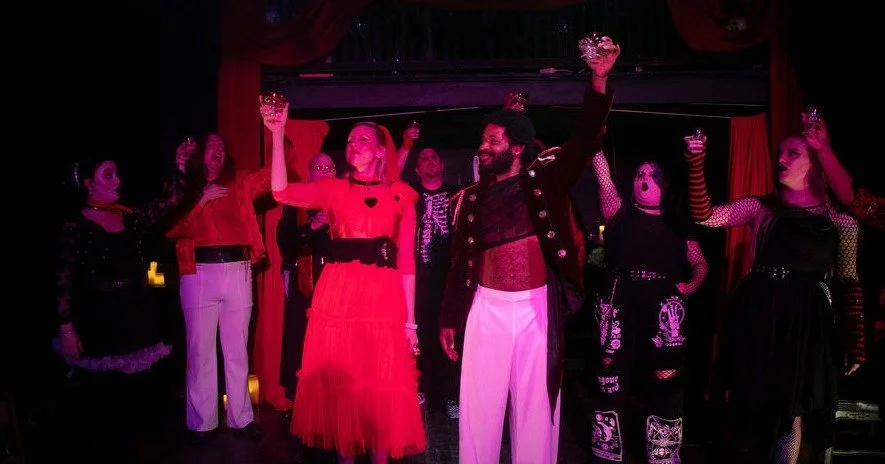 This night you are cordially invited to a Wedding/Funeral...
a Reunion/Betrayal... 
a Romance/Tragedy... 
Paint your eyes dark as pitch and don your best chains, we're taking you into the city to see a marching band...
It's opening night of Hamlet / 