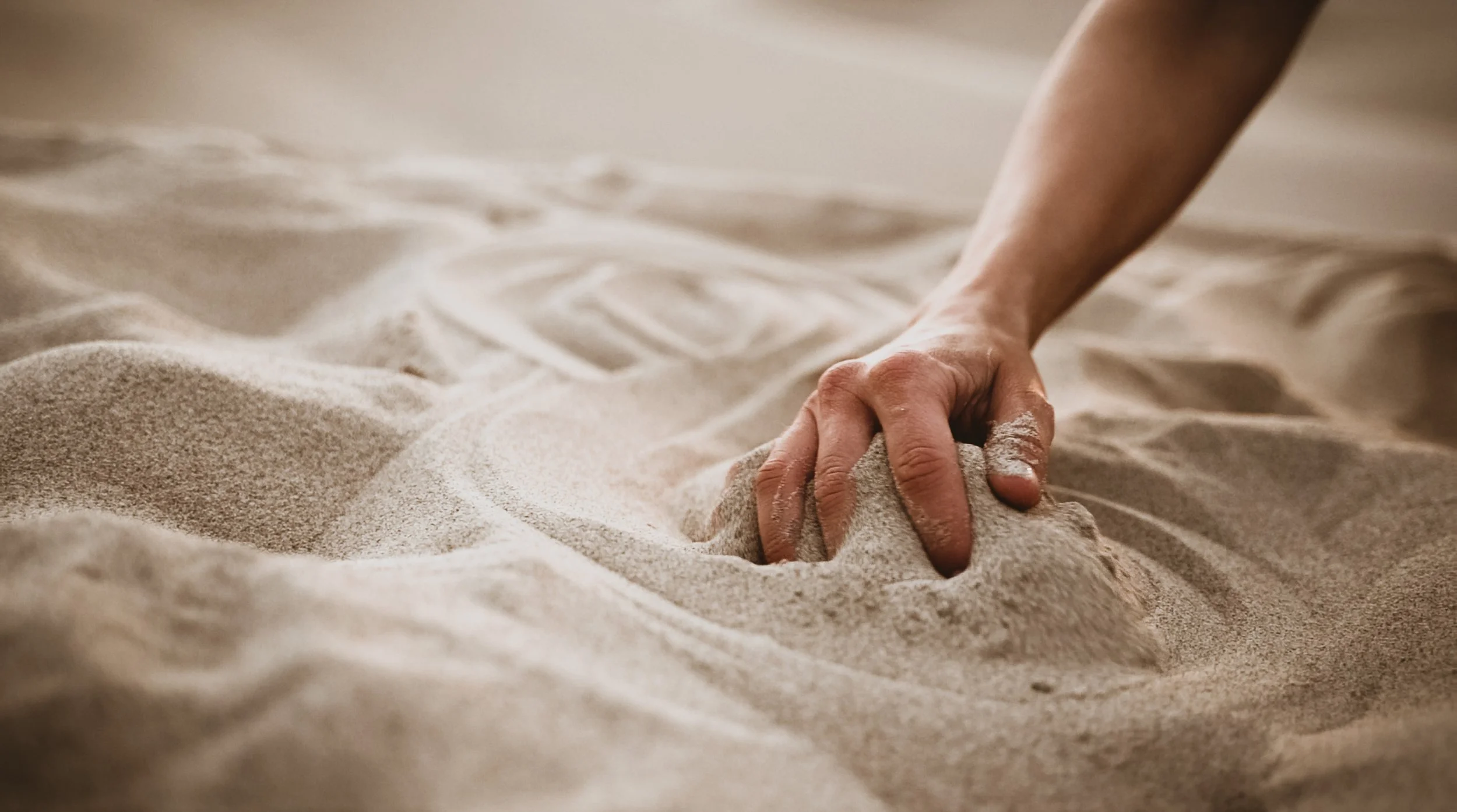 KINRGY performer connecting with the sand in Death Valley landscape.
