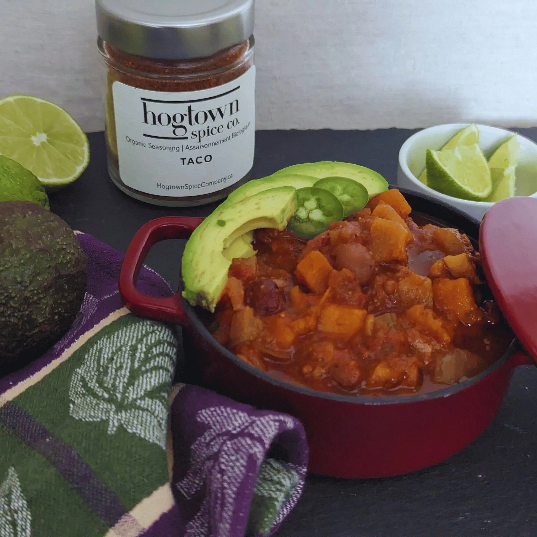 Hearty slow cooker vegetable chili with chunks of sweet potato, kidney beans, and fire-roasted tomatoes, seasoned with a smoky taco spice blend