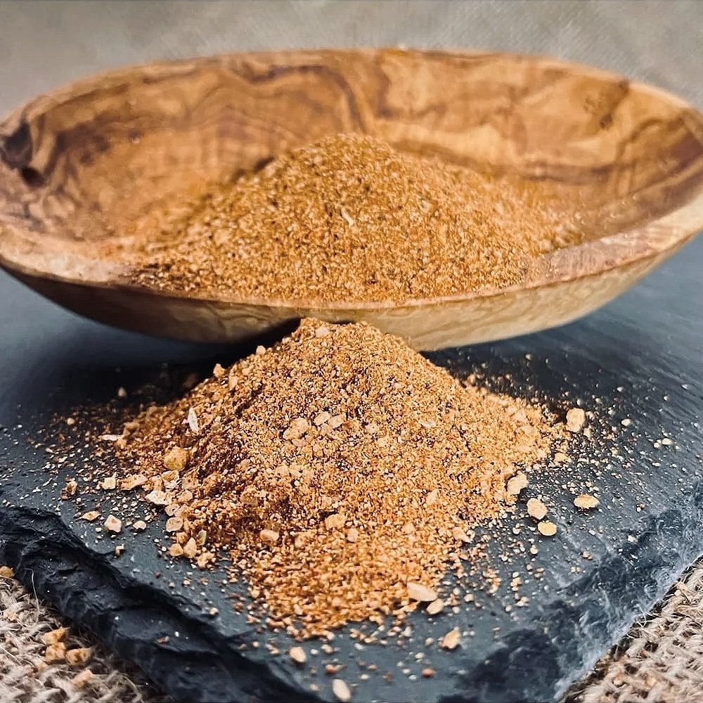 Hogtown Spice Company Organic Taco Seasoning granules in a wood bowl; a gluten-free and vegan spice blend.