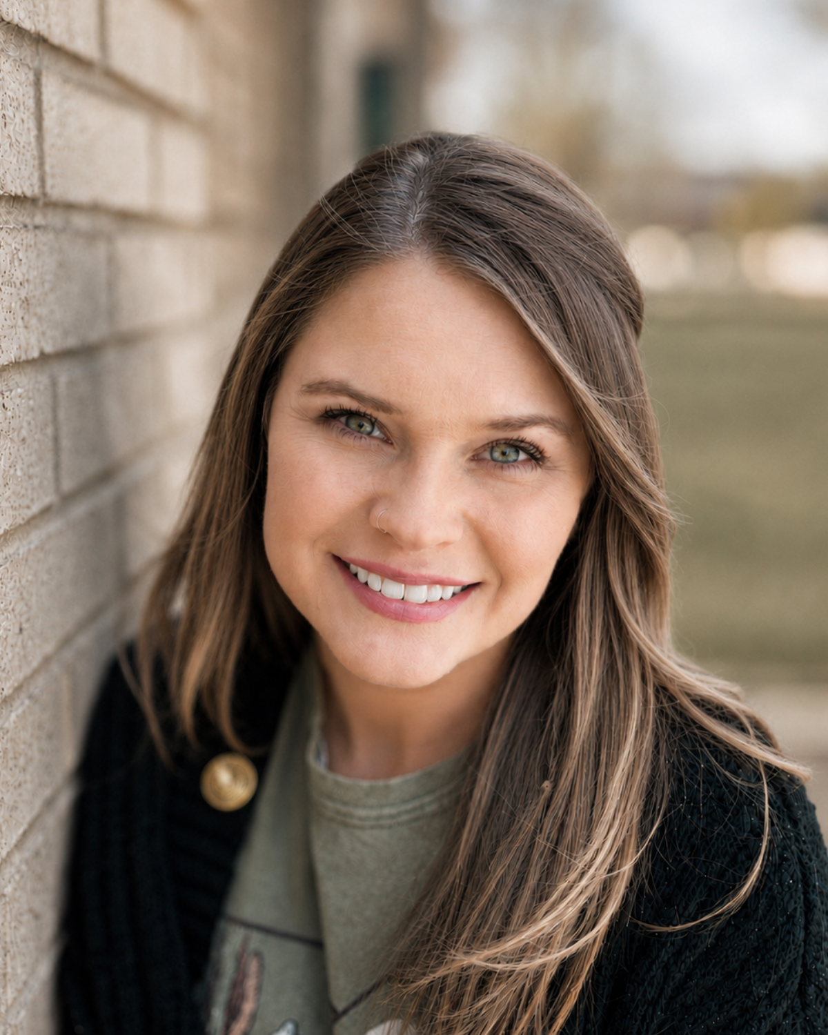 Photo of Amber White, the Brand Marketing Director, outside holding a camera.