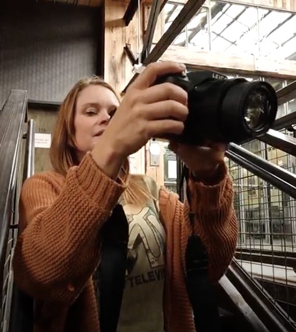 Branded Rebels team member filming social media content with a camera.
