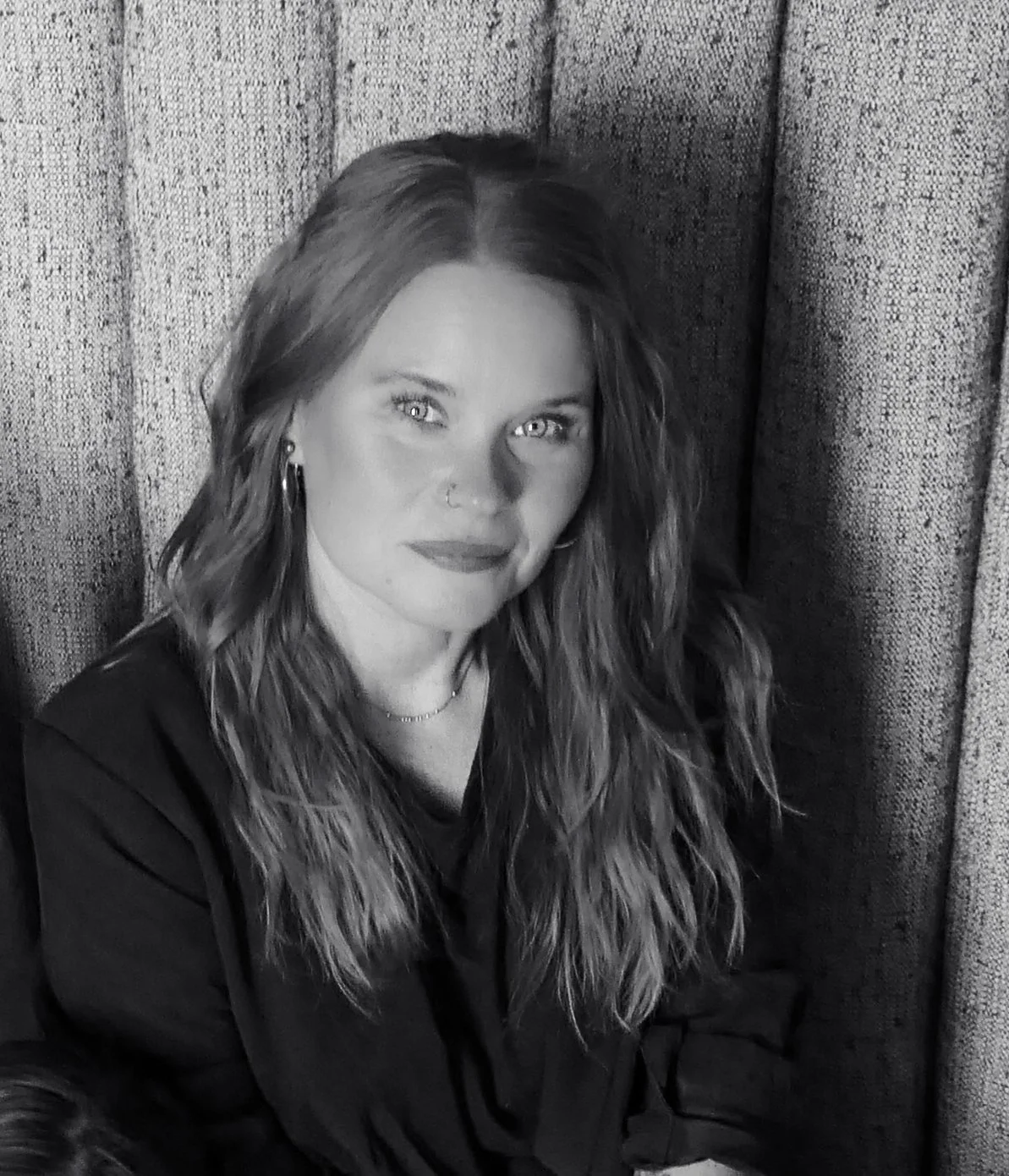 Photo of Amber White, the Brand Marketing Director, outside holding a camera.