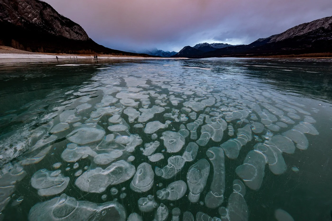 Methane bubbles in ice Abraham Lake Alberta at sunset