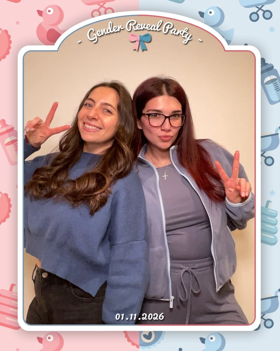 Two women posing for a photo at a gender reveal party, making peace signs with their hands. One woman has long curly brown hair and the other has long straight reddish hair with glasses. The photo is framed with a pink and blue border with baby-theme