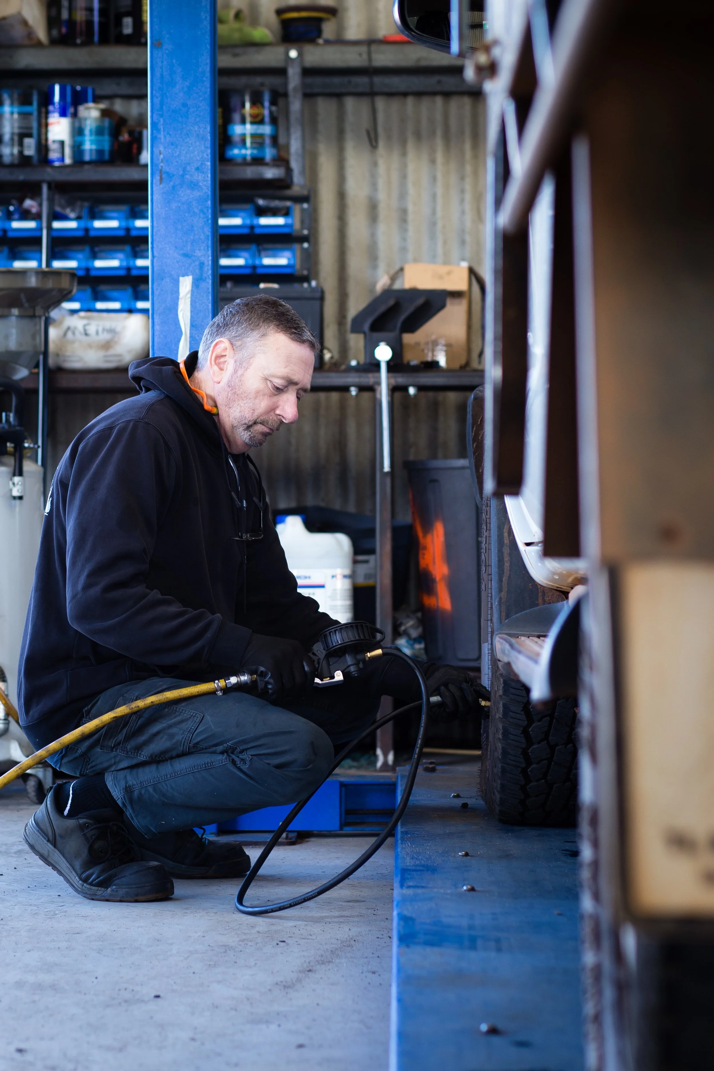 Mechanic working on a lifted SUV at Busselton Auto Repairs