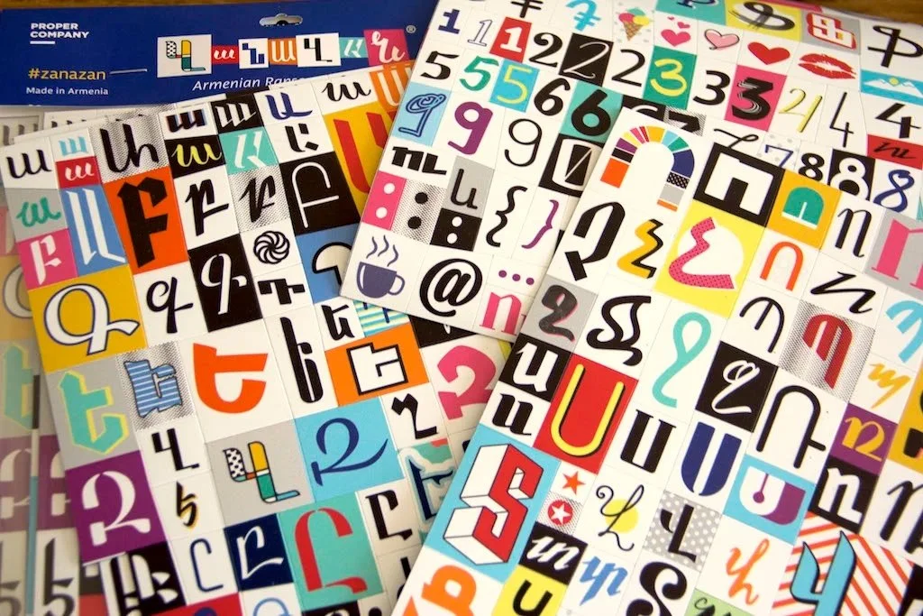 alphabet letters printed on magnet sheets, colorful sheets, stacked over each other.