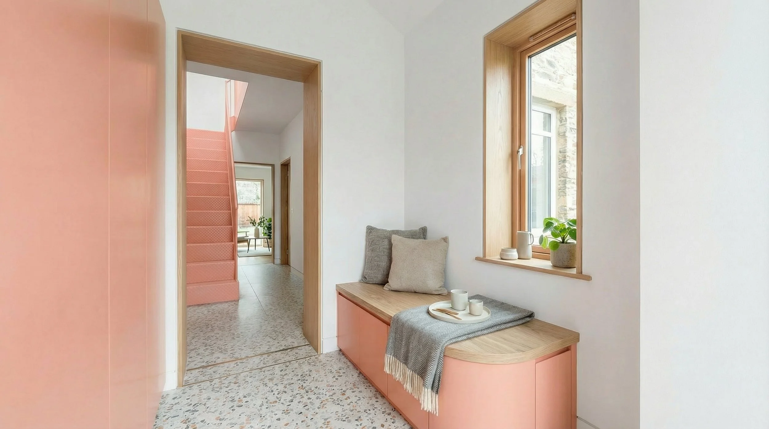 Entrance porch with pink storage bench, terrazzo flooring and oak-framed doorway leading to hallway, residential renovation West Yorkshire.