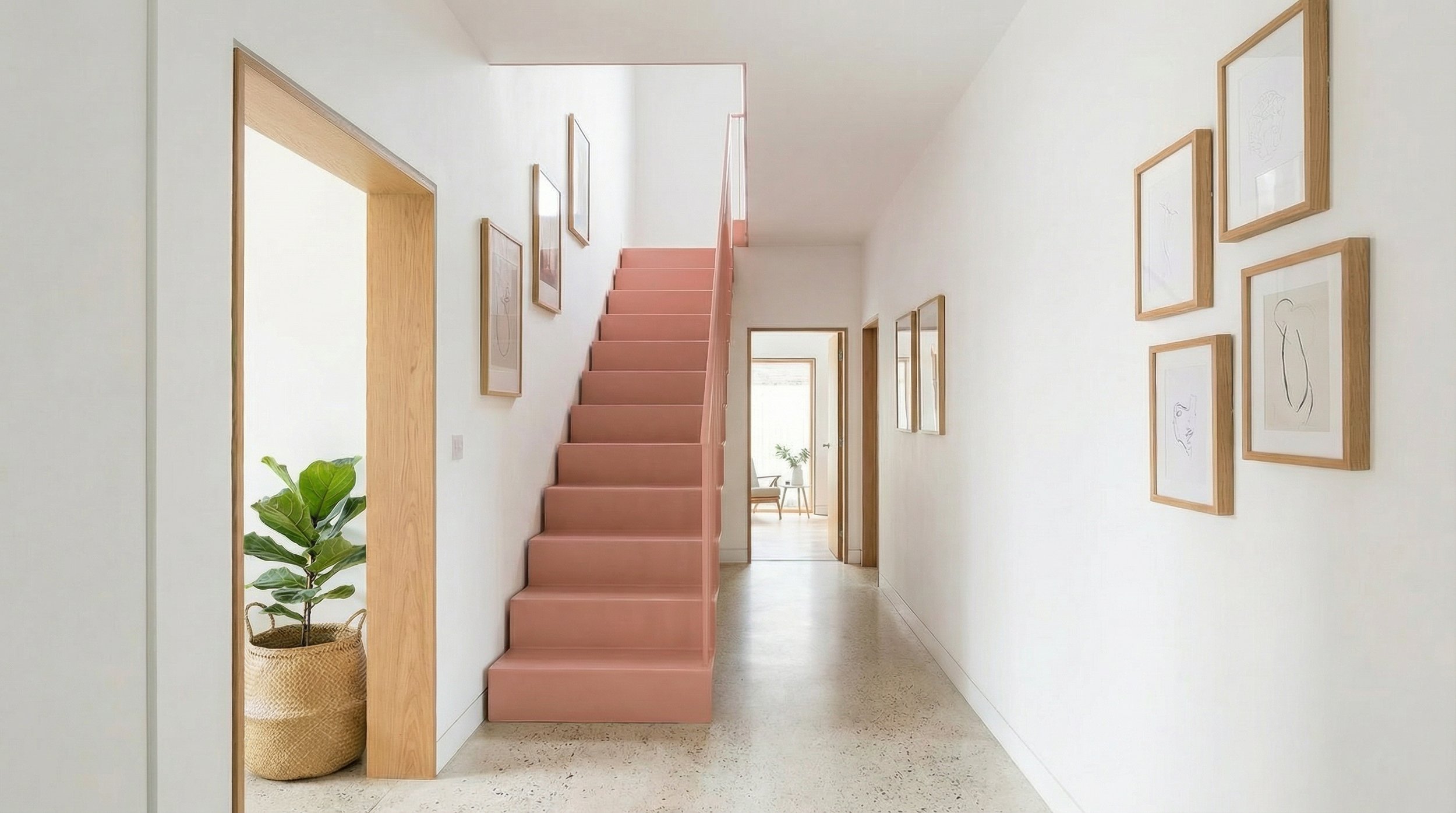Ground floor hallway with pink painted staircase, terrazzo flooring and oak door frames, residential house renovation.