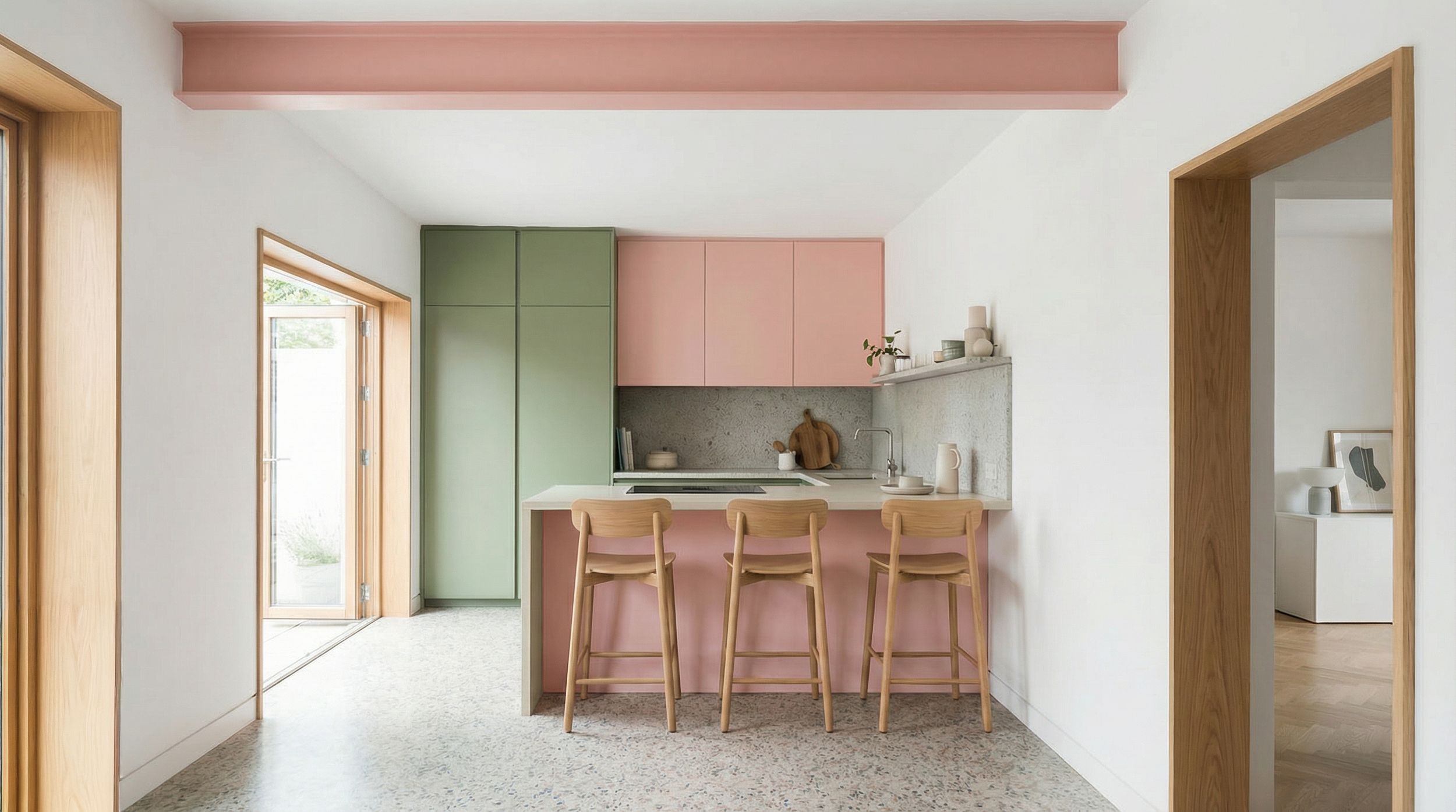 Kitchen and dining area with pink cabinetry island, terrazzo floor, oak shelving and monstera plant, interior design project.