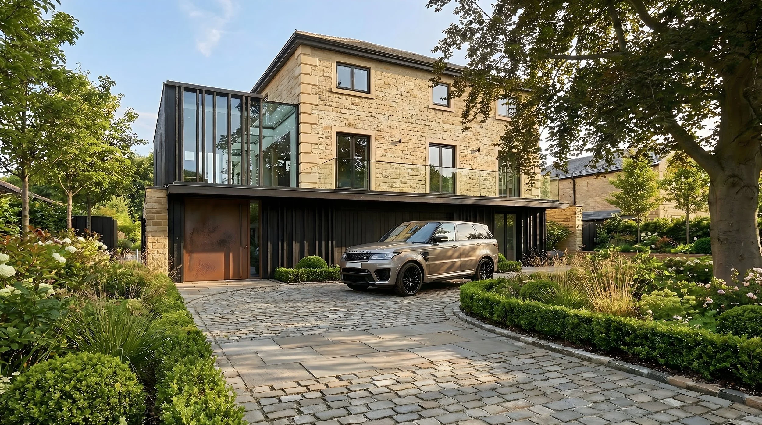 Contemporary stone and black zinc house with corten steel entrance door, cobblestone driveway and landscaped front garden, luxury residential design.