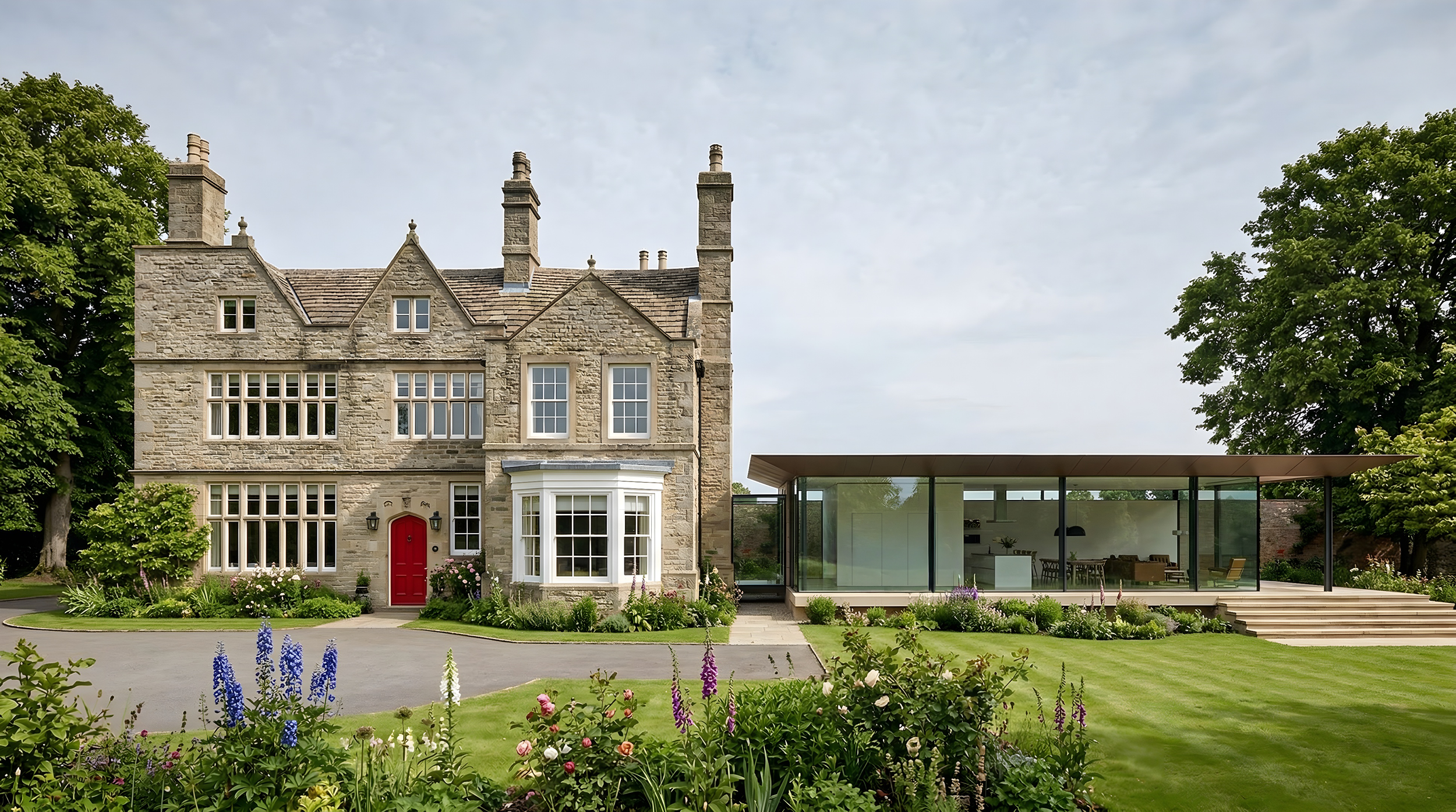 Front elevation of Victorian stone manor house with contemporary full-height glass extension and timber canopy, landscaped garden West Yorkshire.
