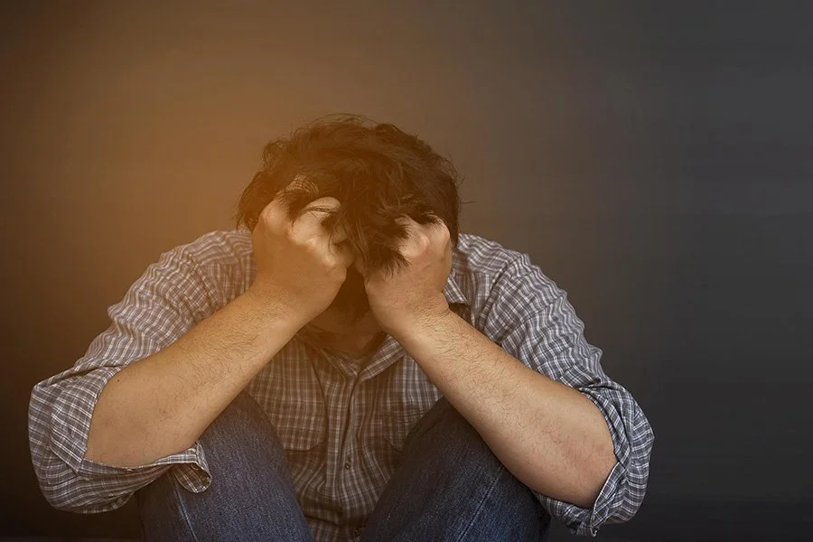 sad-man-holding-head-with-hand-free-photo.jpg
