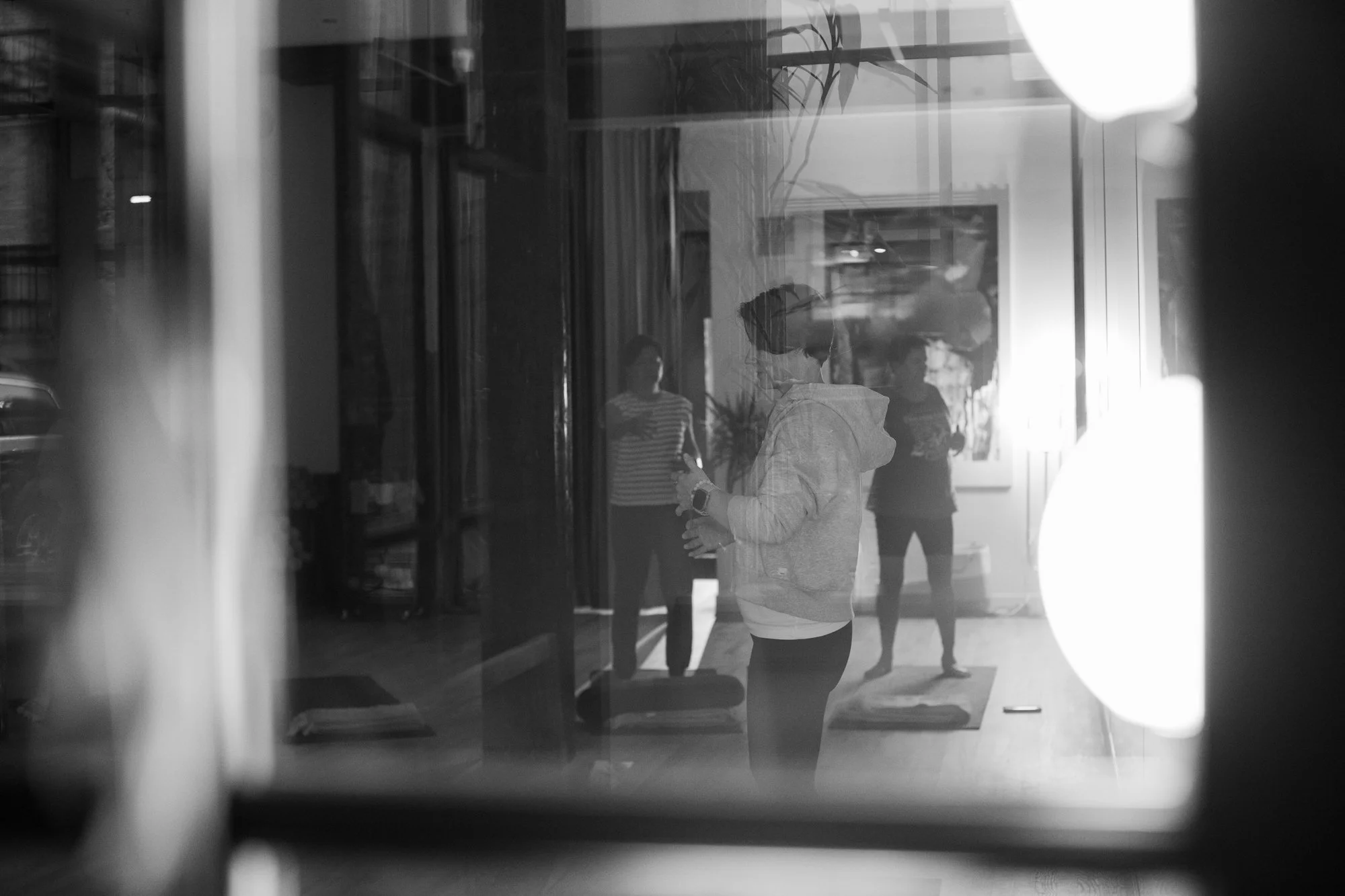 Kari guiding qigong movements during a qigong class.