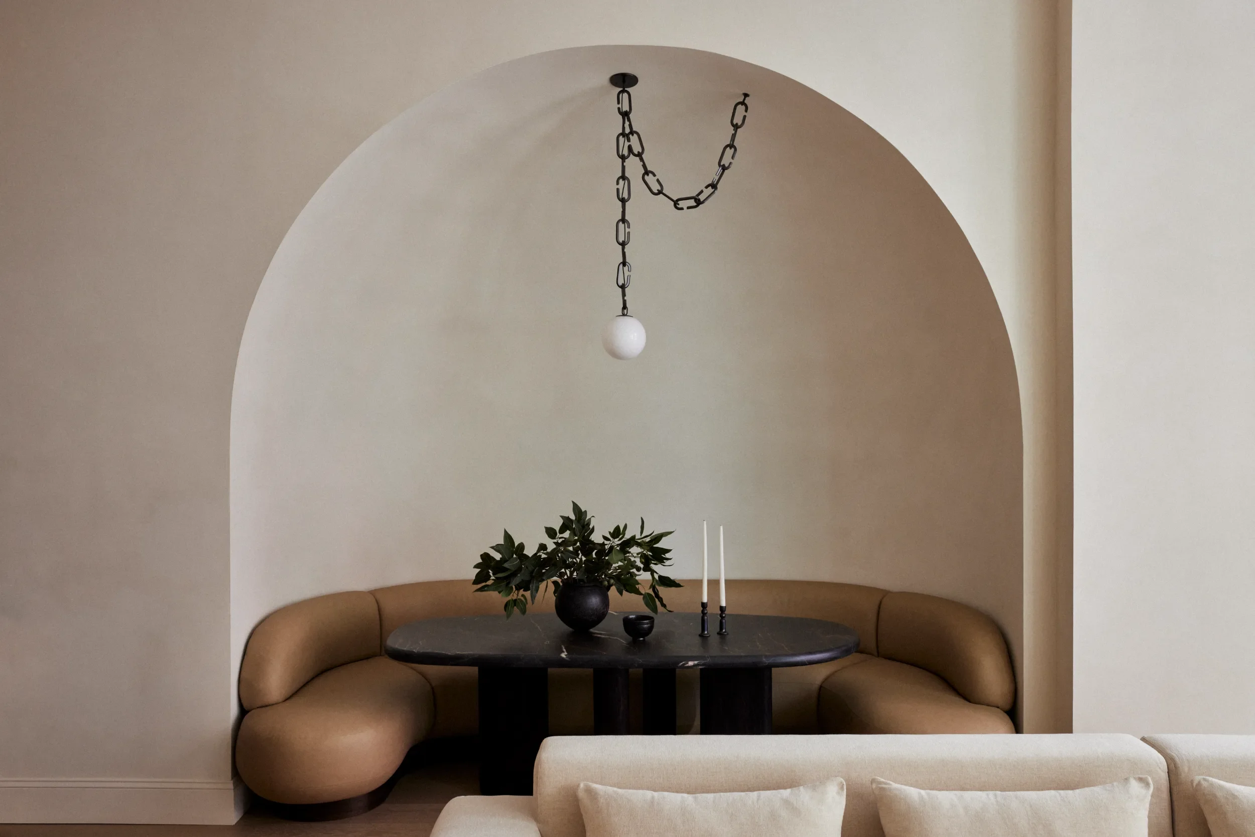 Arched dining nook with a curved banquette in the White Street apartment, Tribeca, renovated by NGM Remodeling
