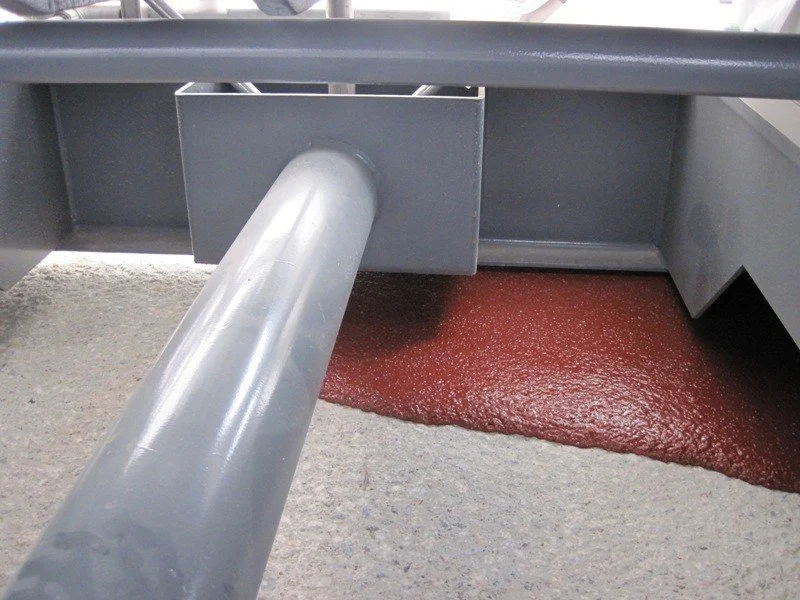 Chockfast Red epoxy grout cured beneath industrial machinery base plate