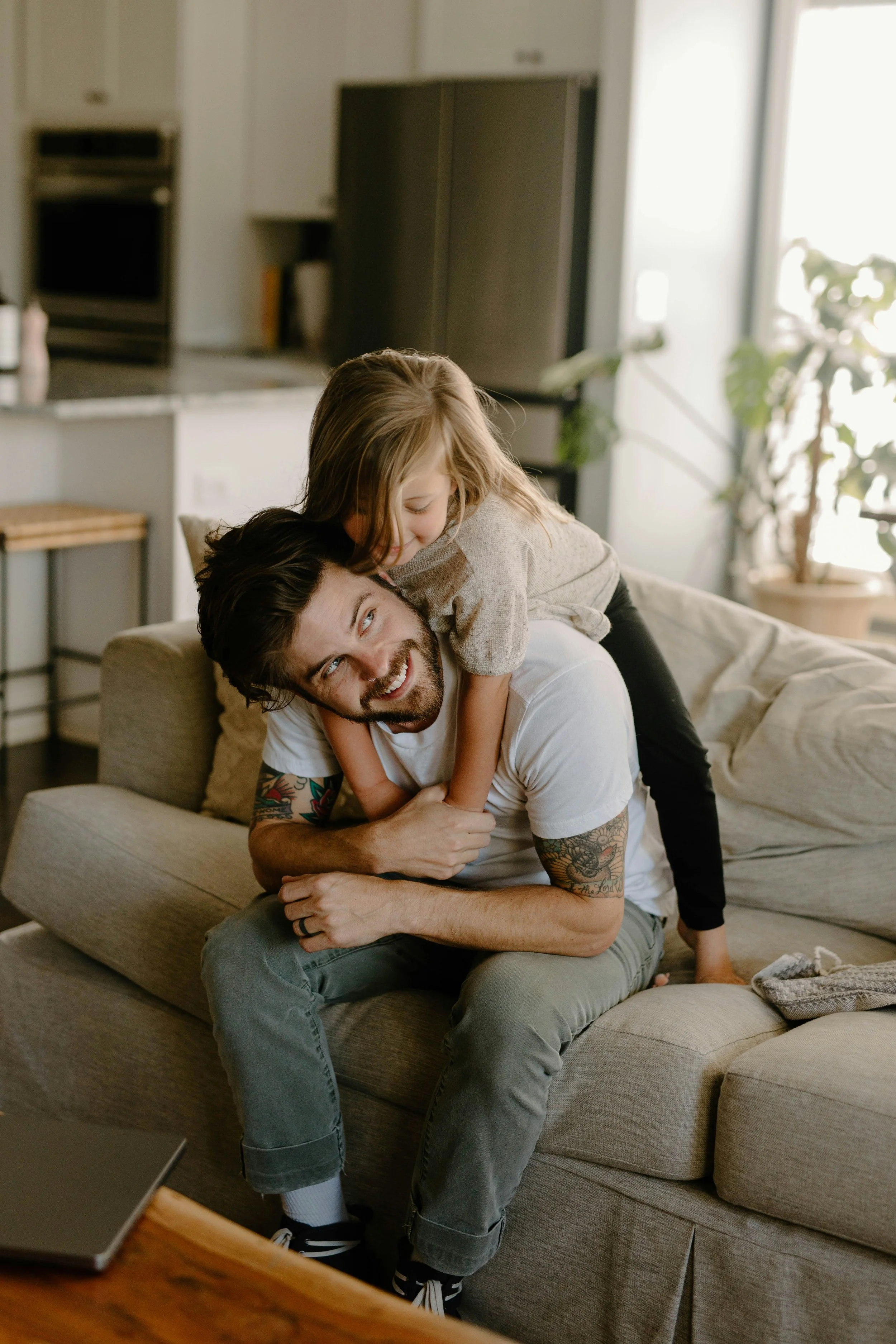 A father and daughter at home together looking happy and healthy