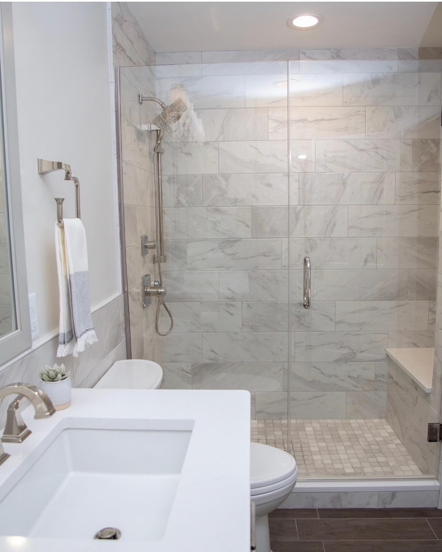 In this bathroom, we selected a porcelain tile for the surround with a great price point for the marble look the client wanted! Budget win and it looks gorgeous! @thetileshop