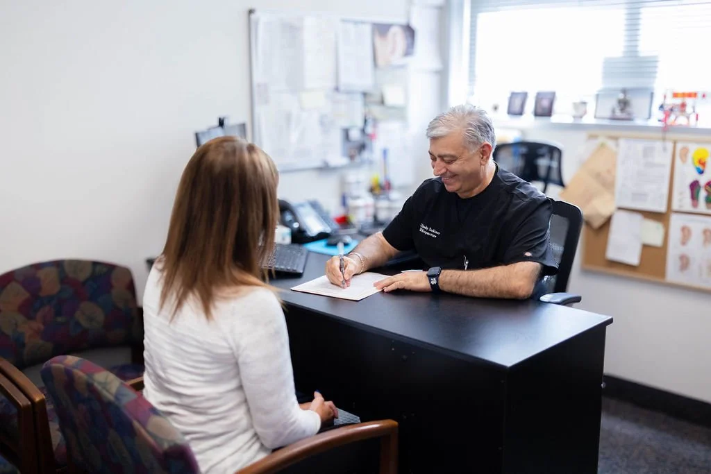 Dr Arkadiy Sarkisov in clinic office consultation with patient 1 ((c) SAY Acupuncture | All Rights Reserved).jpg